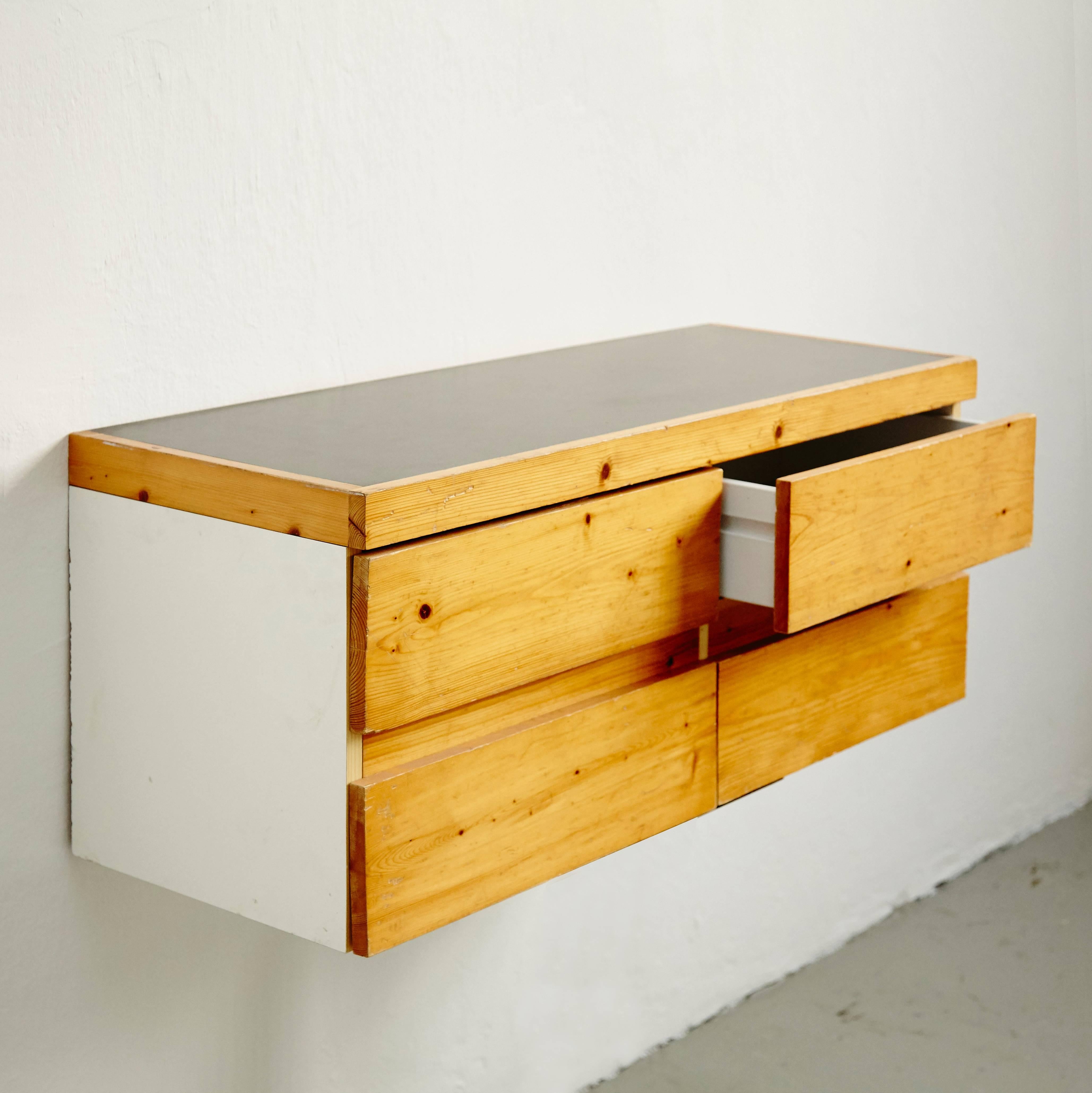 Sideboard designed by Charlotte Perriand for Les Arcs ski resort, circa 1960, manufactured in France.

Pinewood and metal.

In good original condition, with minor wear consistent with age and use, preserving a beautiful patina.

Charlotte