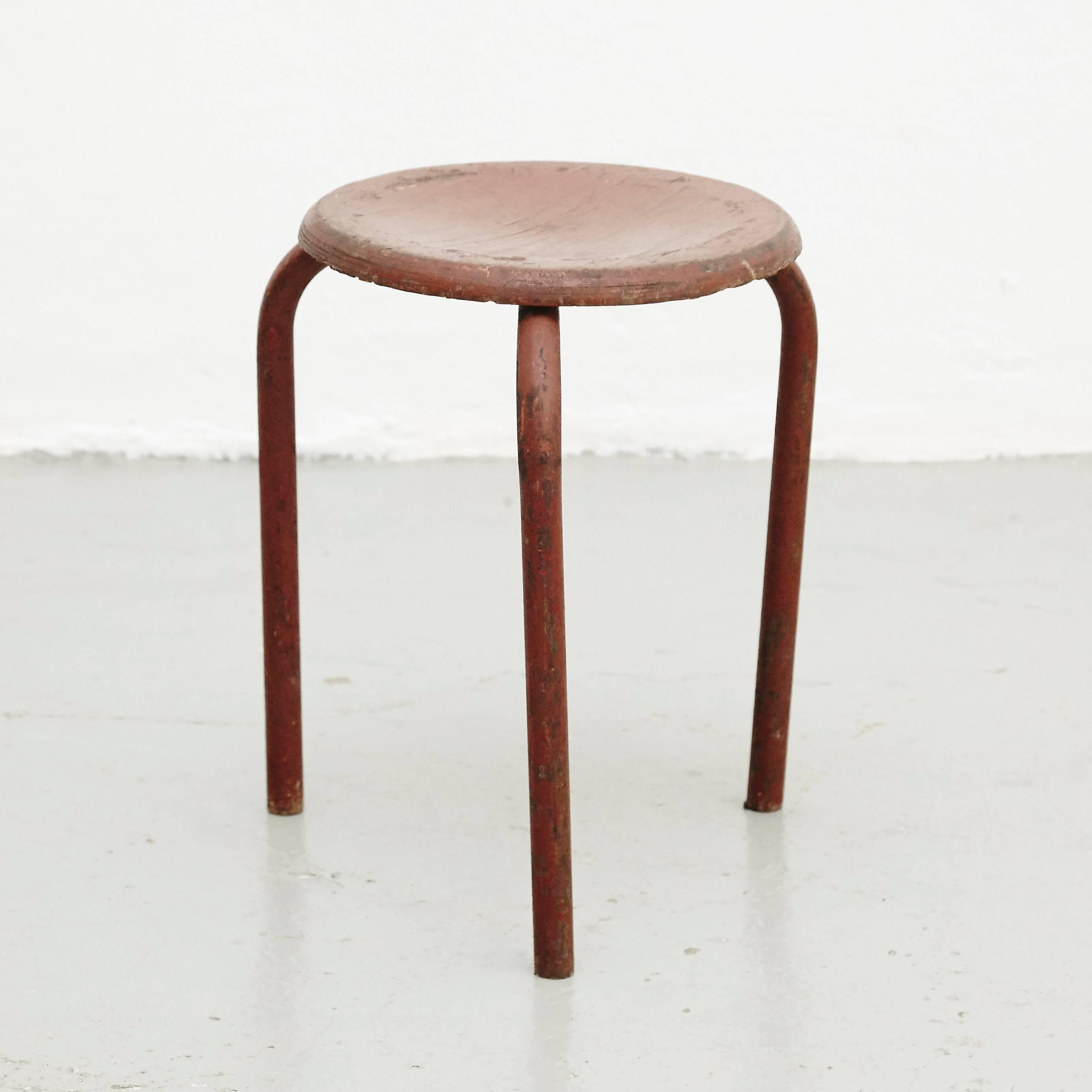 Stool design attributed to Jean Prouvé, circa 1950.
Manufactured in (France.)
Lacquered metal base and laminated wood seat.

In good original condition, with minor wear consistent with age and use, preserving a beautiful patina.