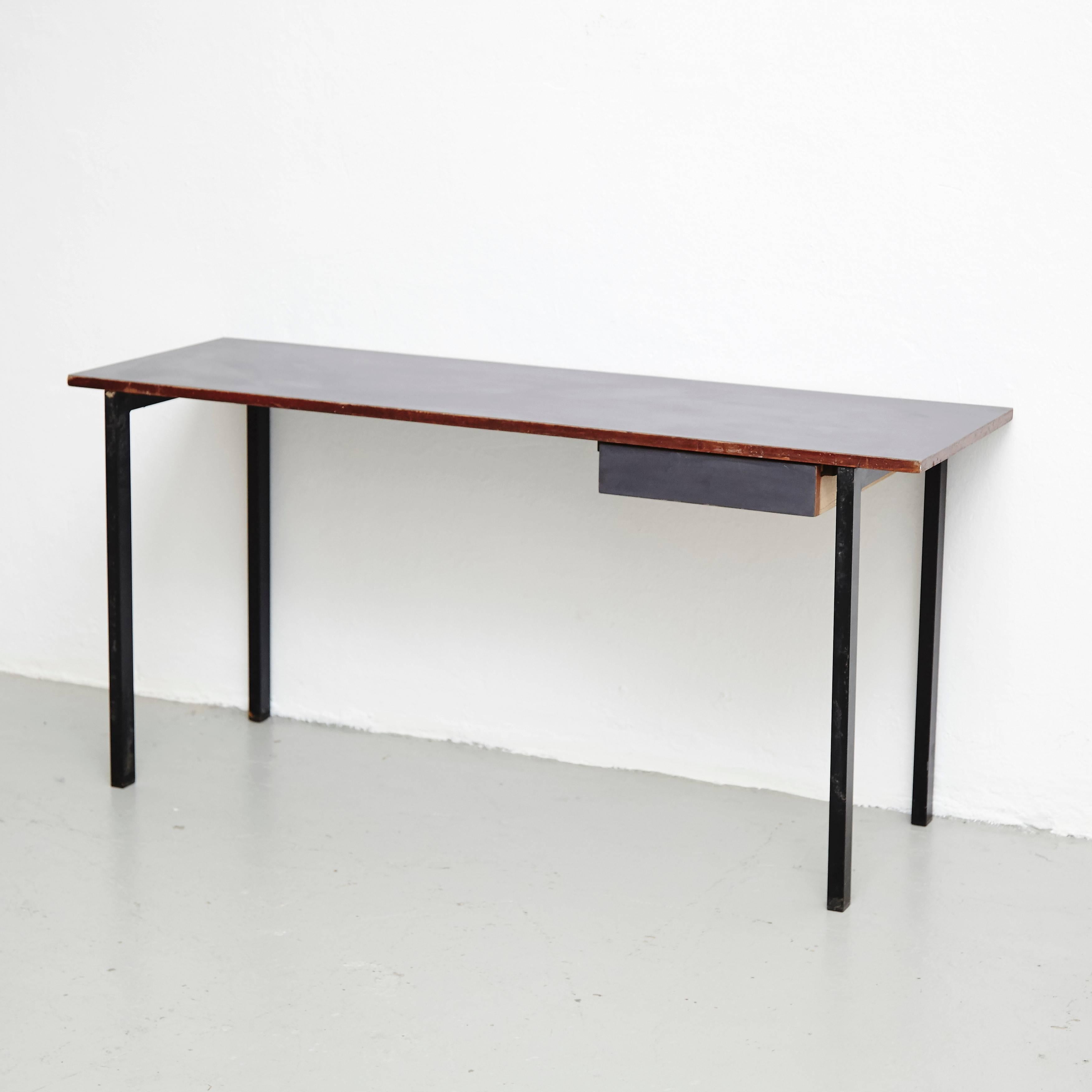 Console from Cite Cansado, Mauritania, designed by Charlotte Perriand.

Wood laminated in formica, structure lacquered metal and fabric.

In good original condition, with minor wear consistent with age and use, preserving a beautiful patina.