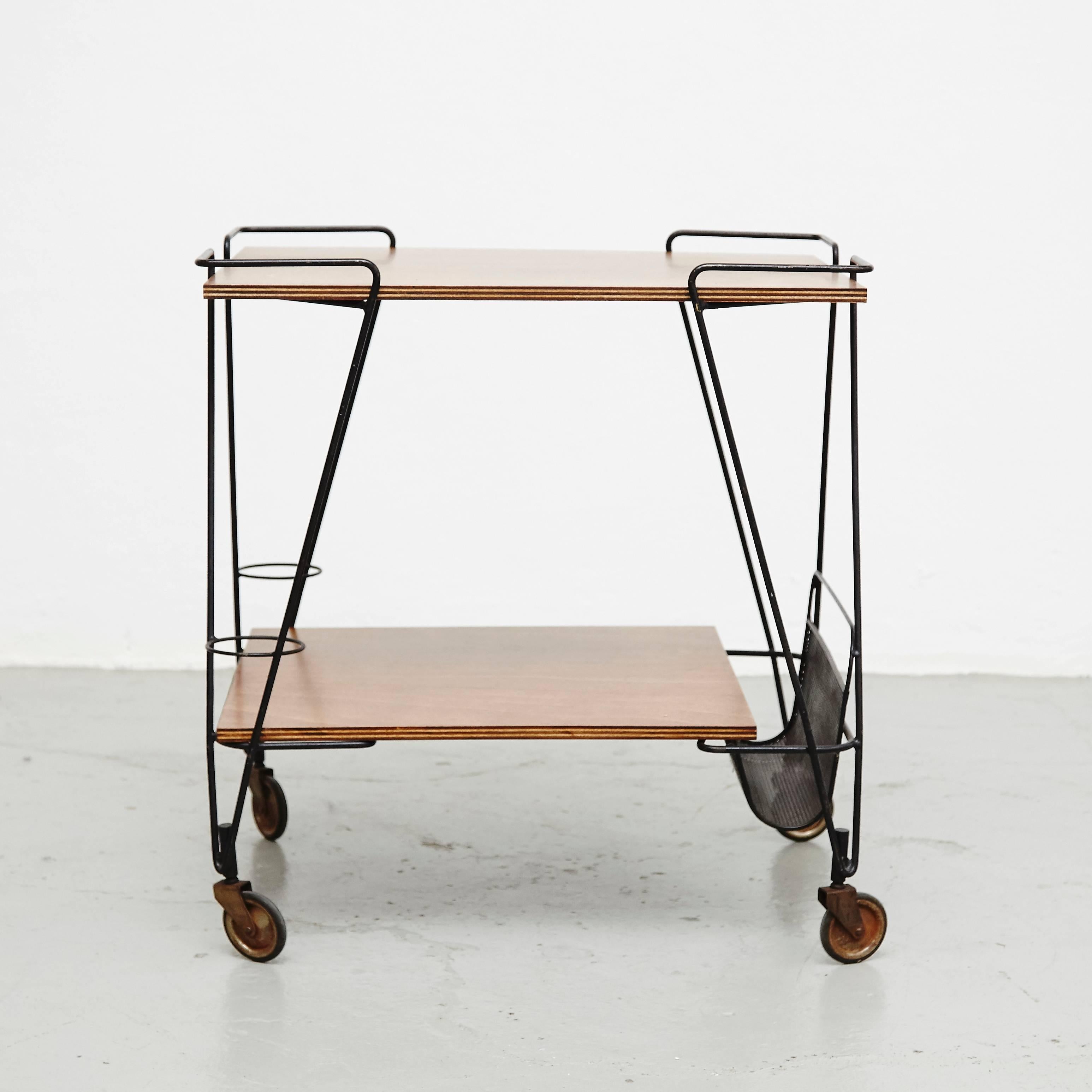 Trolley designed by Mathieu Matégot.
Manufactured by Ateliers Matégot (France), circa 1950.
Perforated metal lacquered in black and laminated wood.

In good original condition, with minor wear consistent with age and use, preserving a beautiful