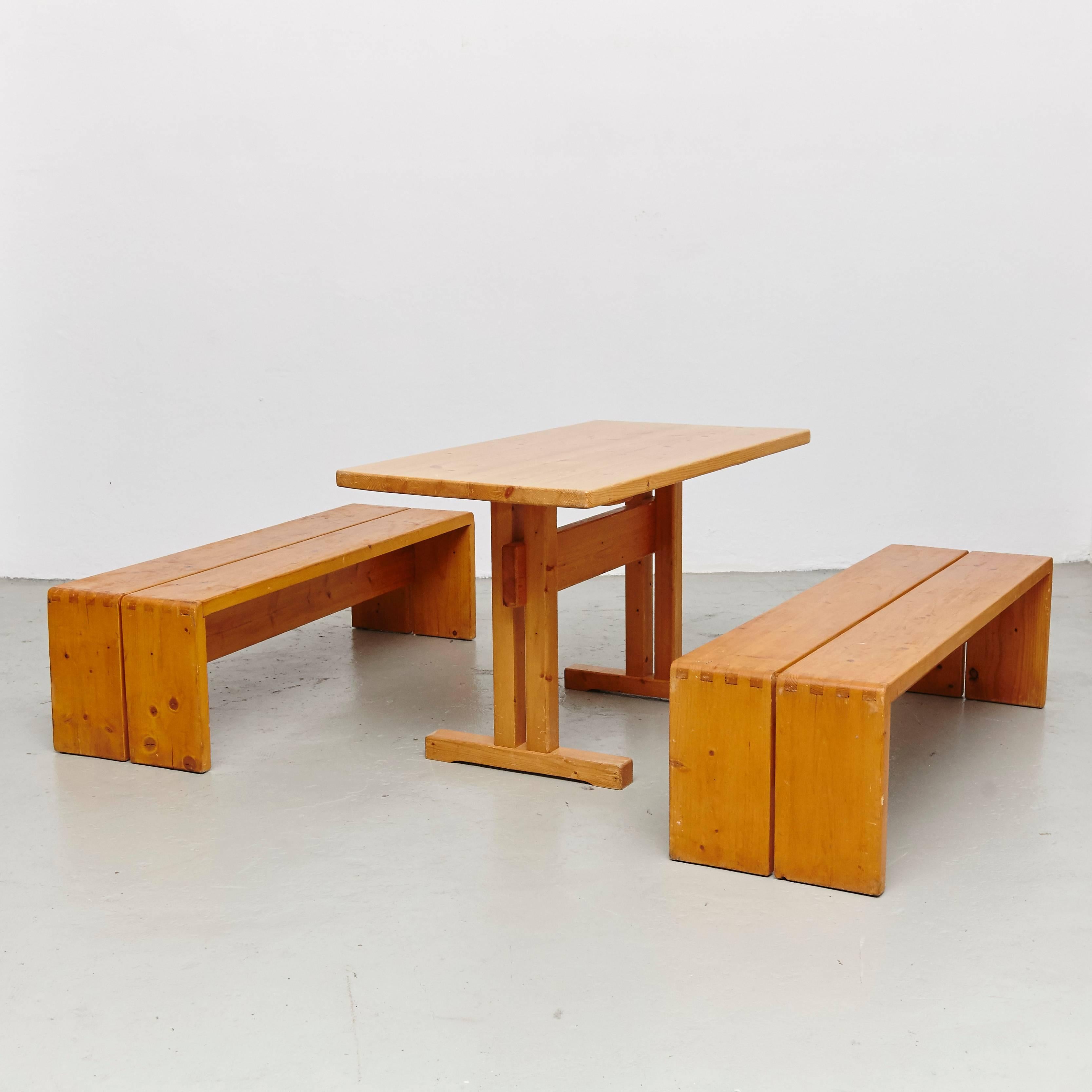 Set of table and benches designed by Charlotte Perriand for Les Arcs ski Resort circa 1960, manufactured in France.

Pinewood.

In good original condition, with minor wear consistent with age and use, preserving a beautiful patina.

Charlotte