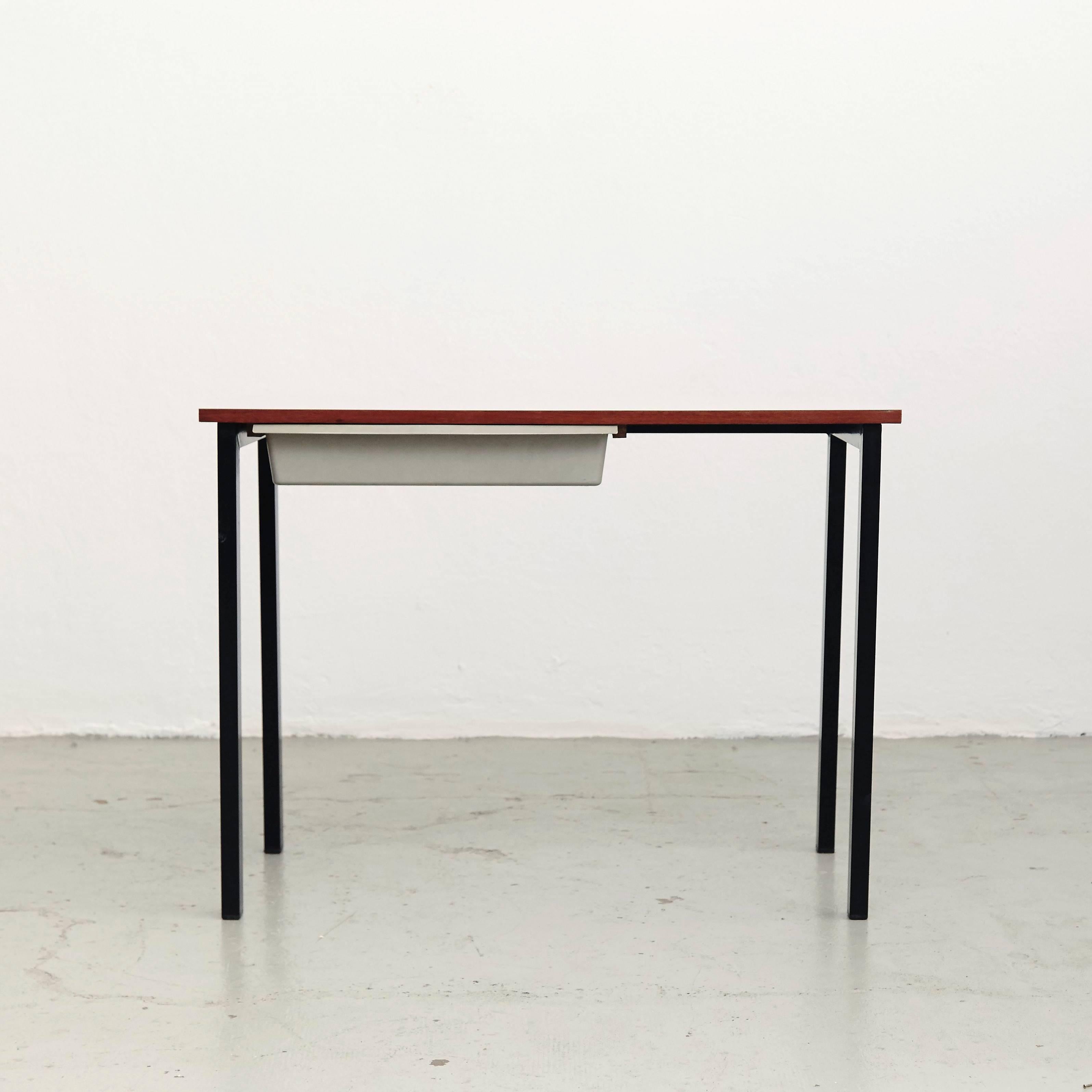Console designed by Charlotte Perriand, circa 1958.
Manufactured in France, circa 1958.
Laminated plastic-covered plywood, painted steel and grey moulded plastic.

Drawer moulded with Modele Charlotte Perriand/Brevete S.G.D.G. 

In good