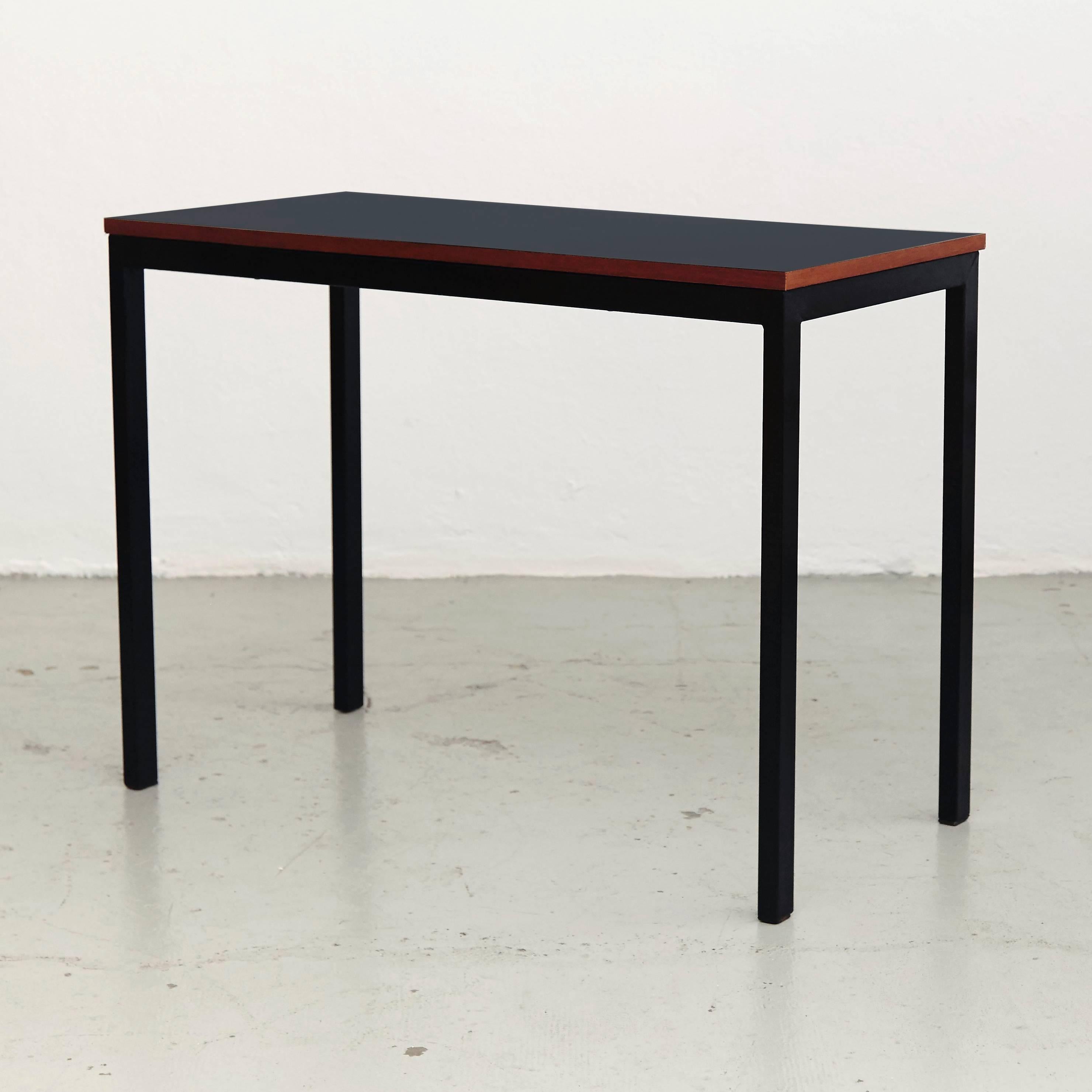 Console designed by Charlotte Perriand, circa 1958.
Manufactured in France, circa 1958.
Laminated plastic-covered plywood, painted steel. 
Black.

In good original condition, with minor wear consistent with age and use, preserving a beautiful