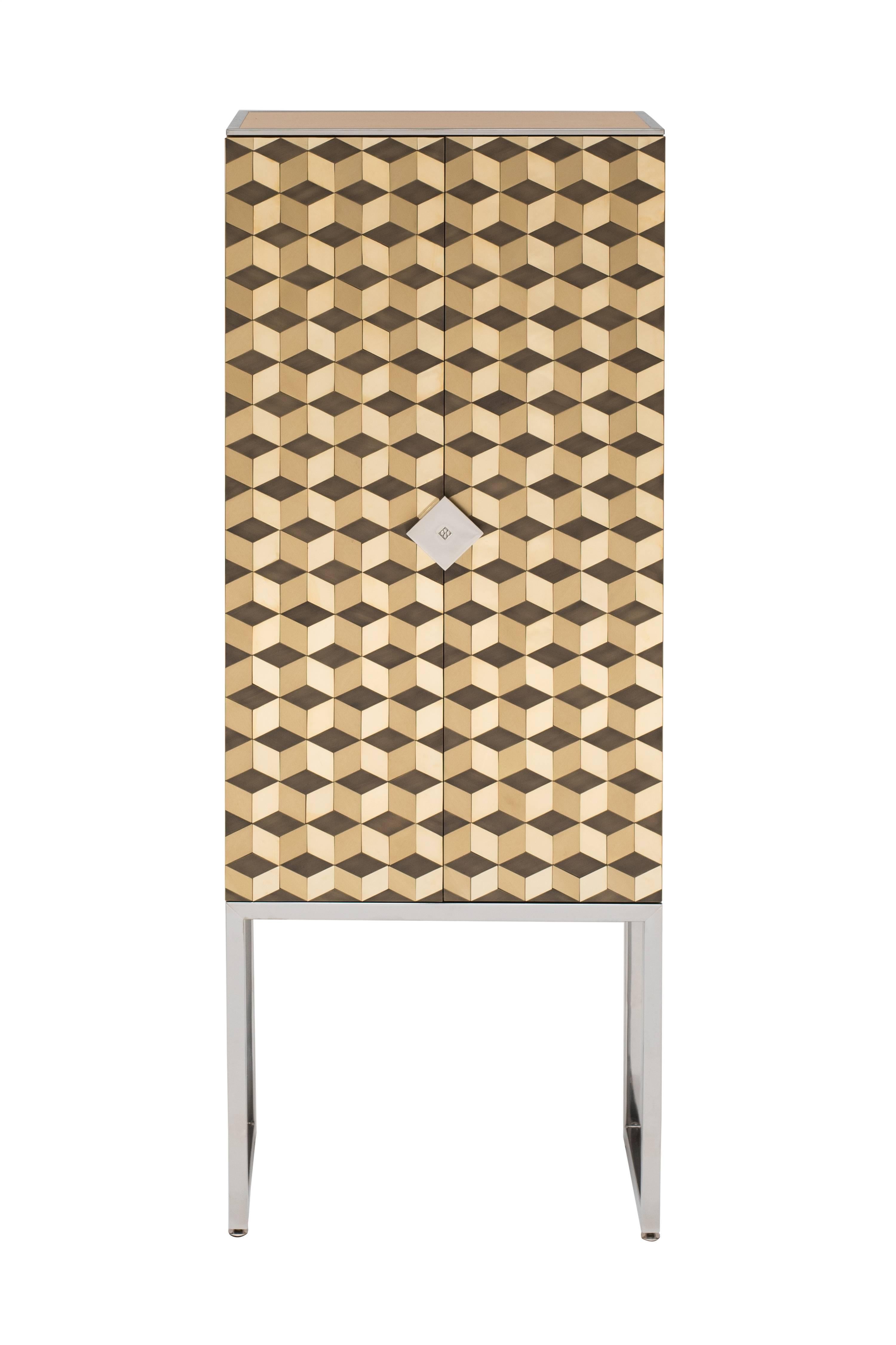 This is a limited edition cabinet by Peter Ghyczy, based on CO3 cabinet. The edition is limited to three pieces. This piece is number one of three.

The front doors are encrusted with 476 tiles in 2 mm brass. Each tile is then polished by hand,