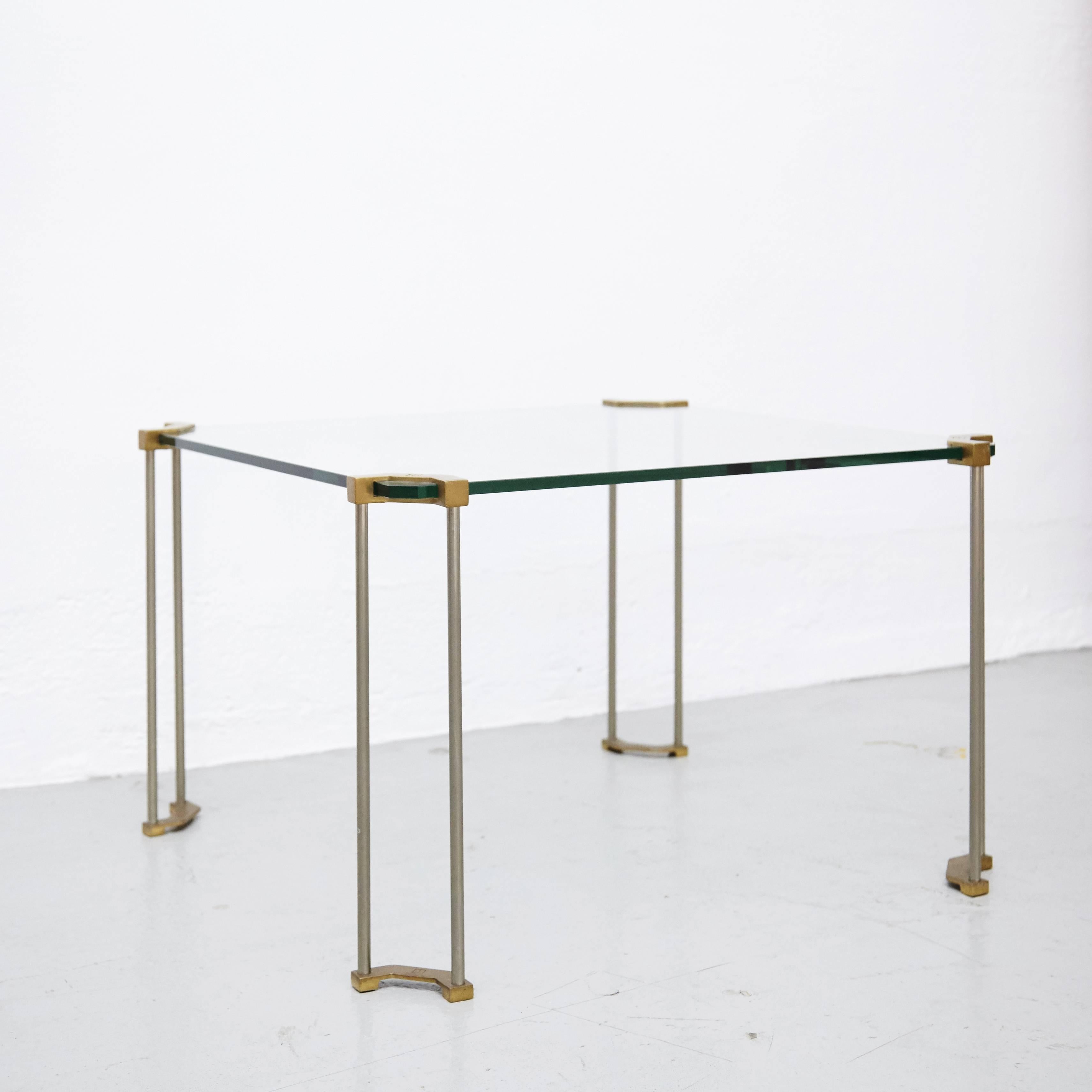 The table is made from glass and sand casted brass. The legs are hand casted by very skilled craftsmen in the Netherlands. The brass has typical characteristics of the casting process and only some parts are polished.

After the Hungarian revolution
