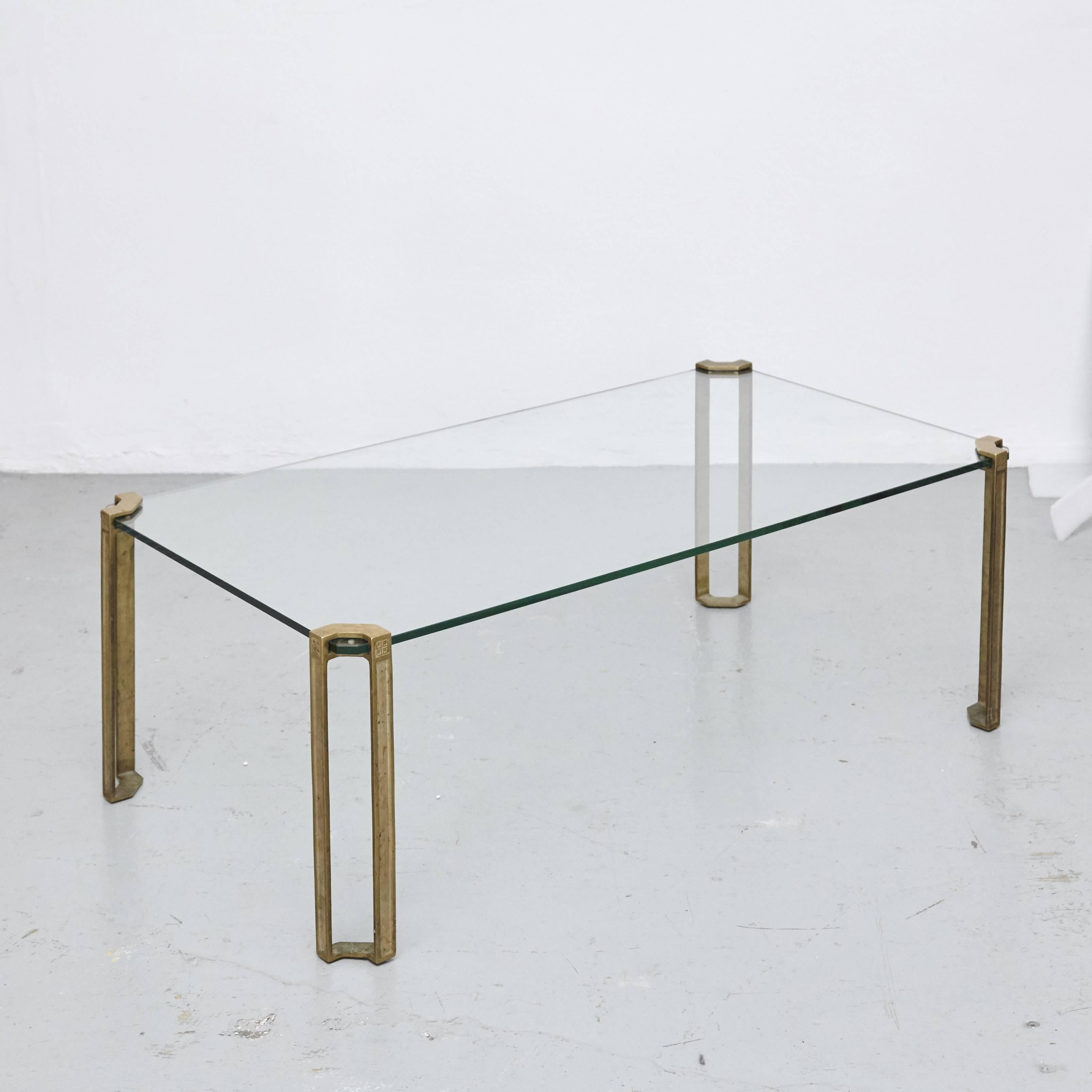 Peter Ghyczy Glass Low Table, circa 1970

The table is made from glass and sand casted brass. The legs are hand casted by very skilled craftsmen in the Netherlands. The brass has typical characteristics of the casting process and only some parts are