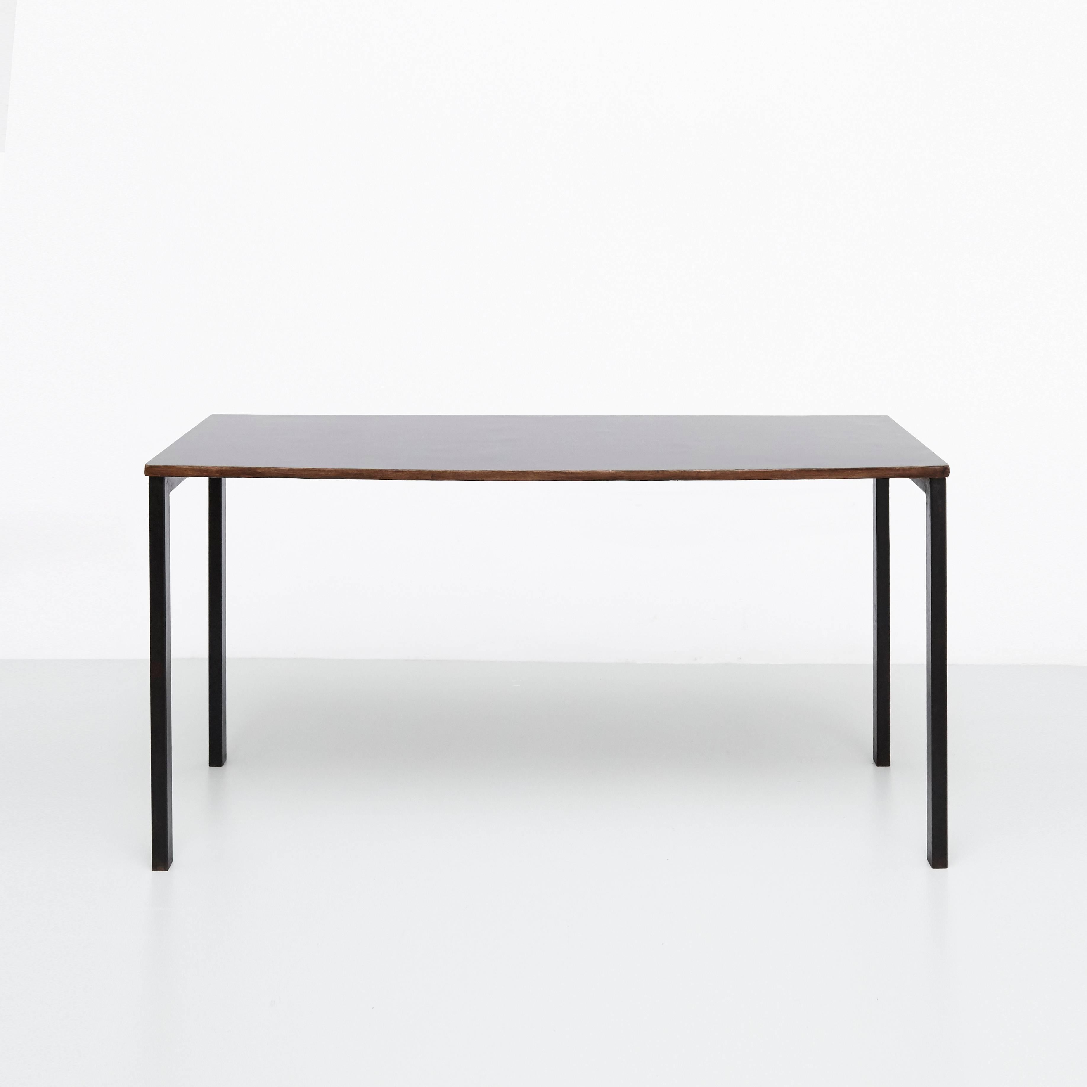 Console designed by Charlotte Perriand, circa 1950.
Manufactured in France, circa 1950.
Black laminated plastic-covered plywood, painted steel.

In good original condition, with minor wear consistent with age and use, preserving a beautiful