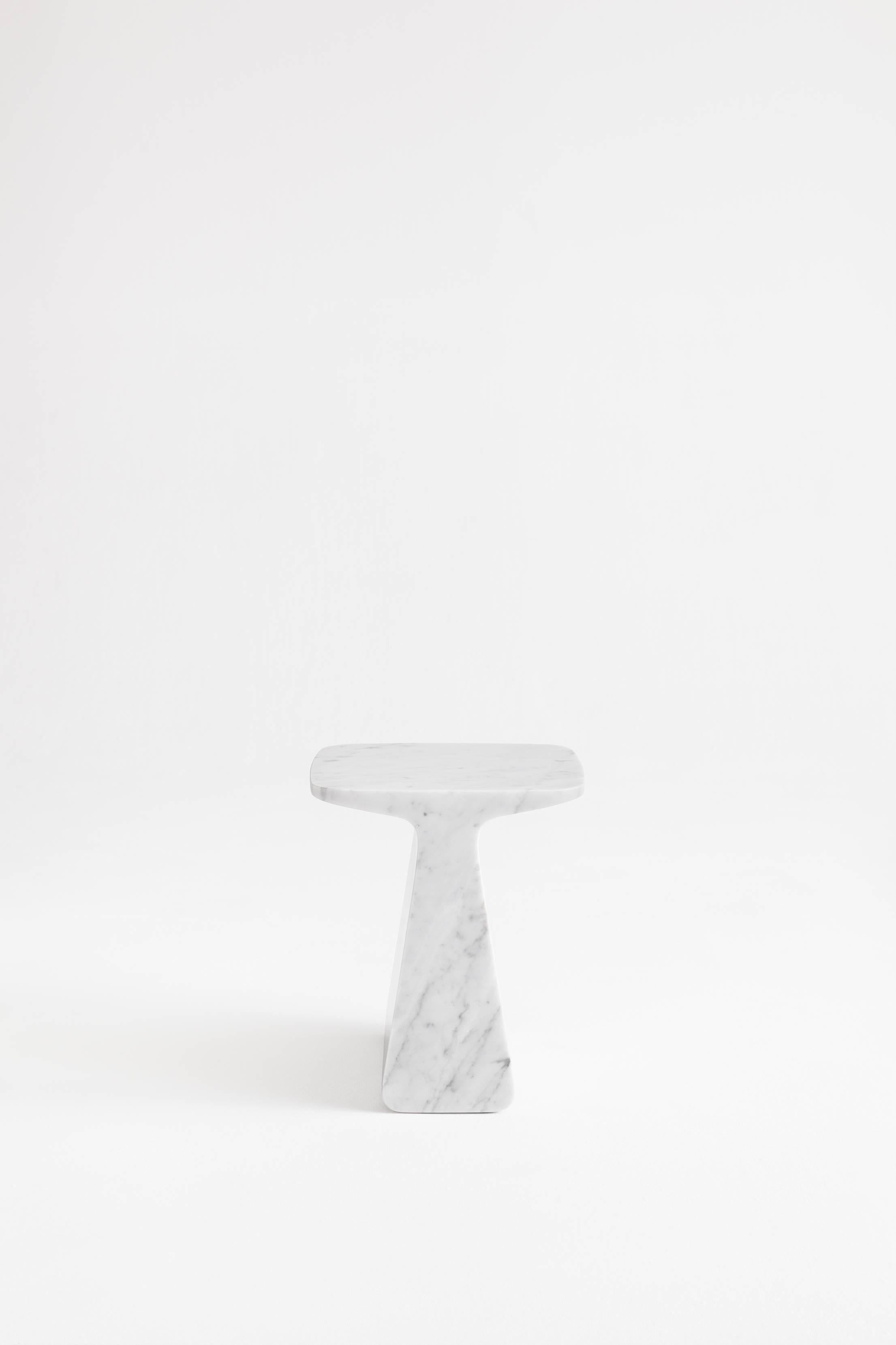 Pura is a side table extracted from a Carrara marble block. Solid and contained, either like a table, a base or a stool, Pura emanates presence and stillness. It's available in white and black marble and its finish is matte.

Designed by Adolfo