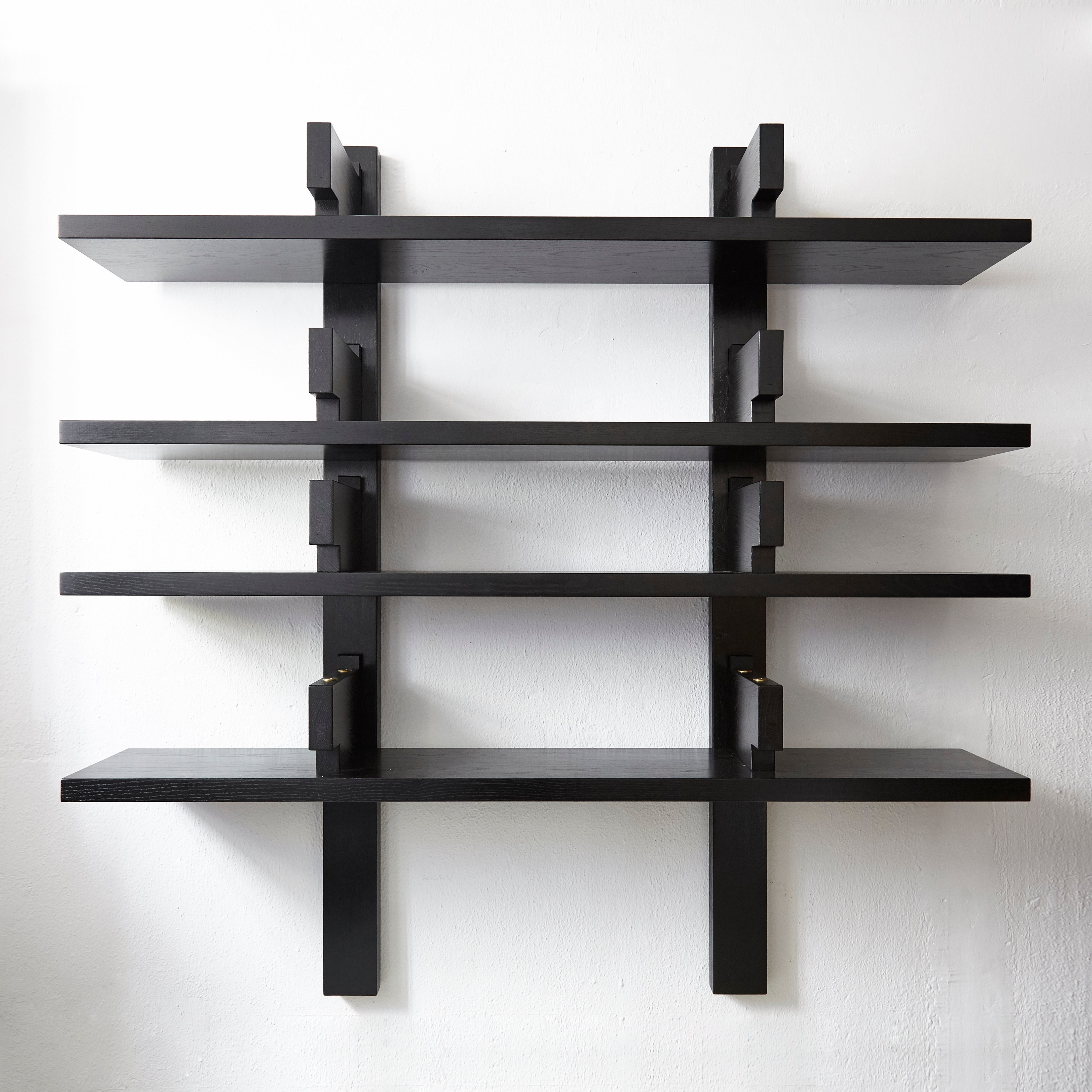 Enhance your interior with the special black edition of the B17 wall-mounted bookshelf, designed by celebrated French designer Pierre Chapo circa 1970. This striking piece, manufactured by Chapo Creation in 2019, showcases the beauty and durability