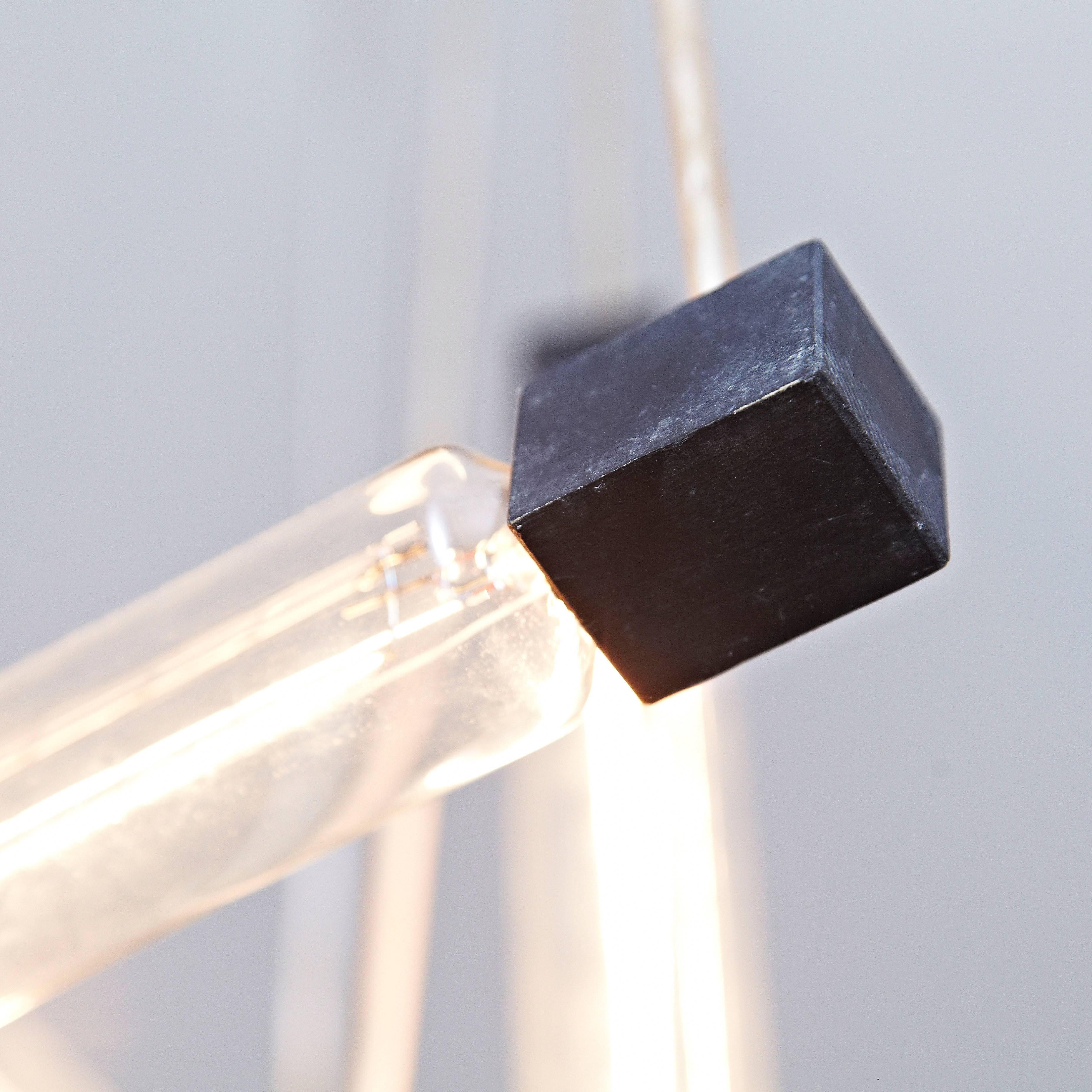 Hanging lamp, designed in the style of Rietveld, executed around 1950 by unknown manufacturer.
Painted wooden structure and plastic tube protecting the electricity cable, with three bulbs.

In good original condition, with minor wear consistent