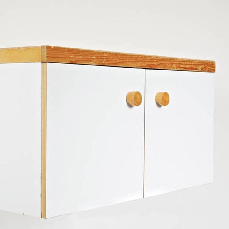 Two doors wall-mounted sideboard designed by Charlotte Perriand for Les Arcs ski resort, circa 1960, manufactured in France.
Pine wood and lacquered top.

In good original condition, with minor wear consistent with age and use, preserving a