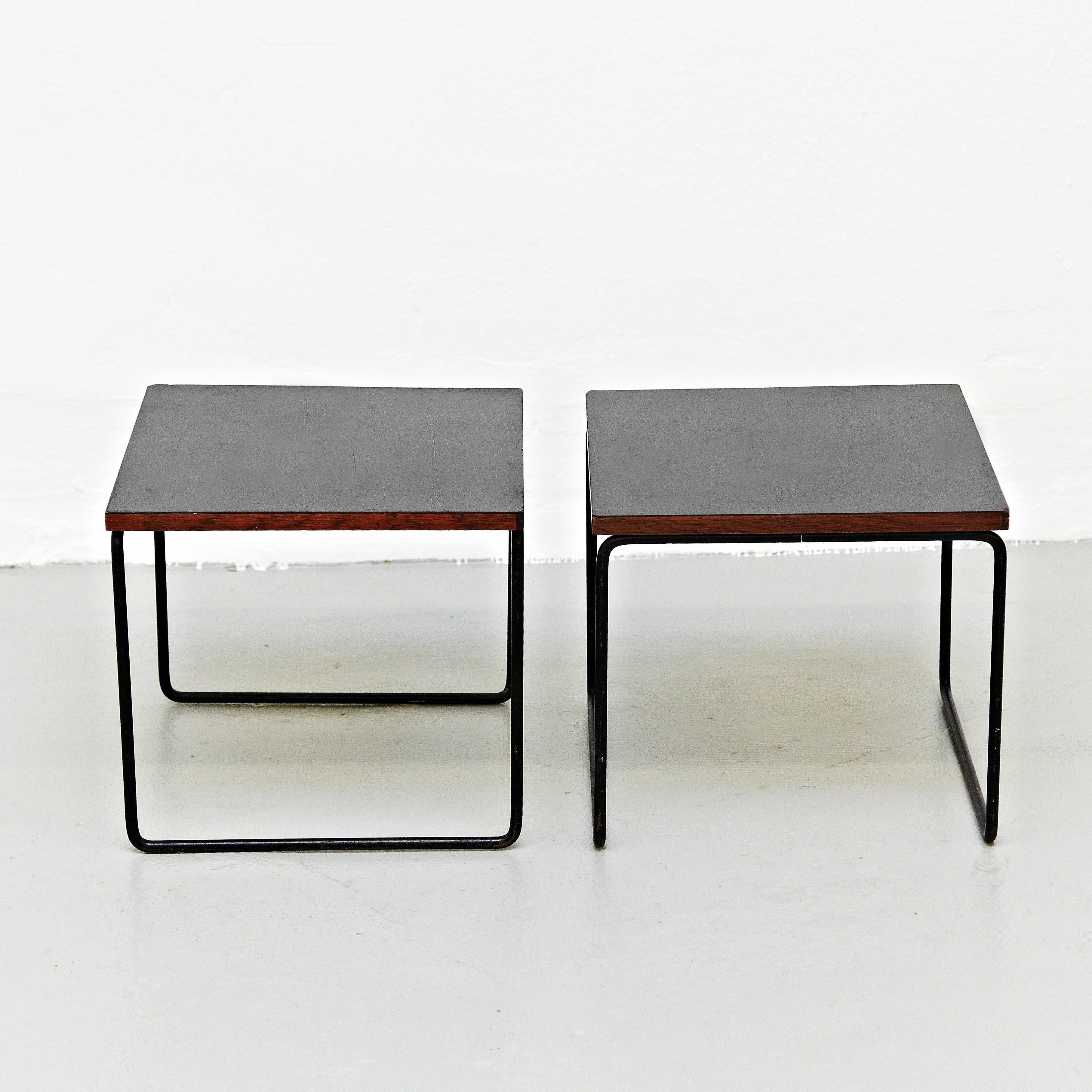 Tables designed by Pierre Guariche. Manufactured by Steiner, (France), circa 1950. Bent and painted iron frame, laminated wood. Signed with applied manufacturer's label to undeside: [Steiner] In good original condition, with minor wear consistent