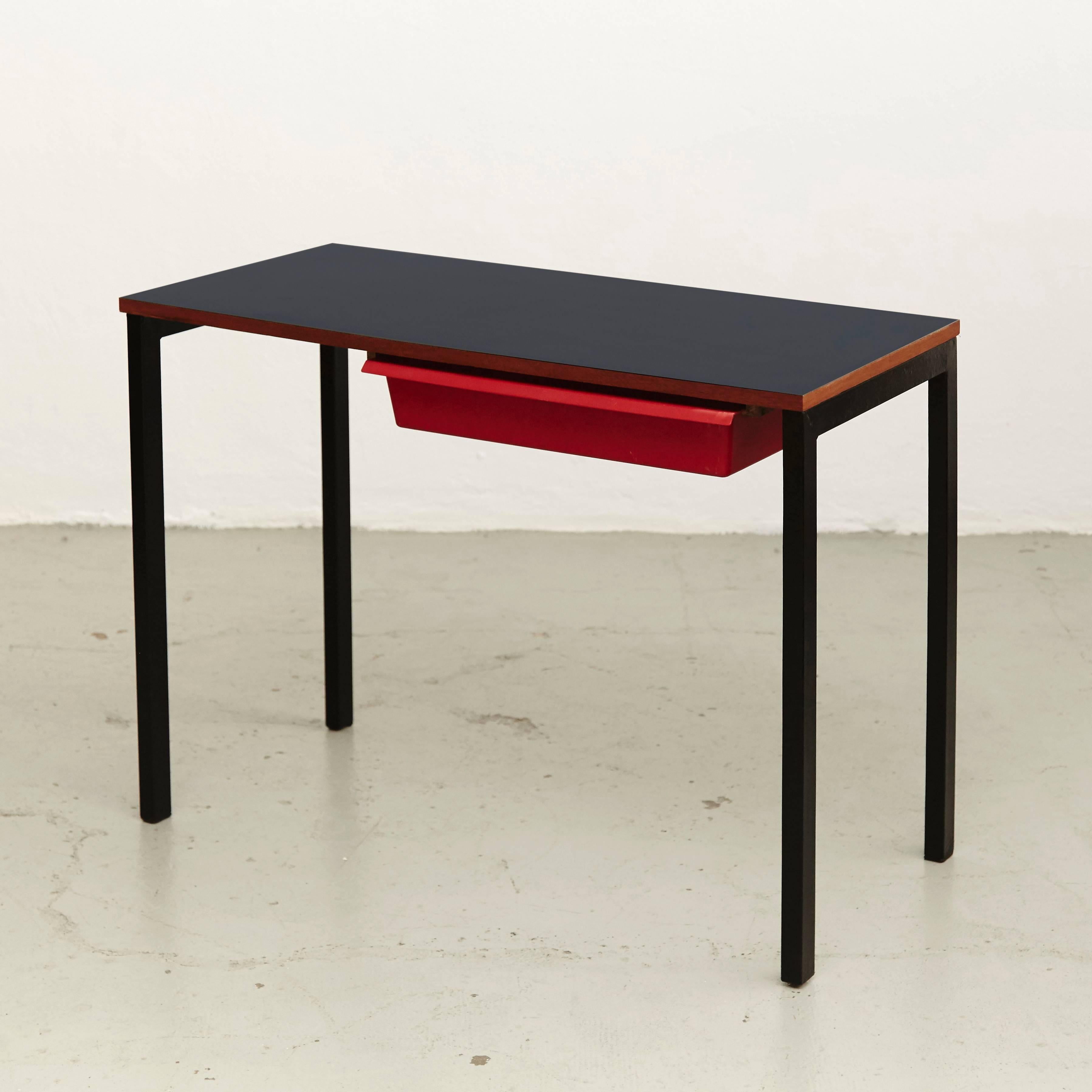 Console with drawer designed by Charlotte Perriand, circa 1958.
Manufactured in France, circa 1958.
Laminated plastic-covered plywood, painted steel and red moulded plastic.

Drawer moulded with MODELE CHARLOTTE PERRIAND/BREVETE S.G.D.G. 

In