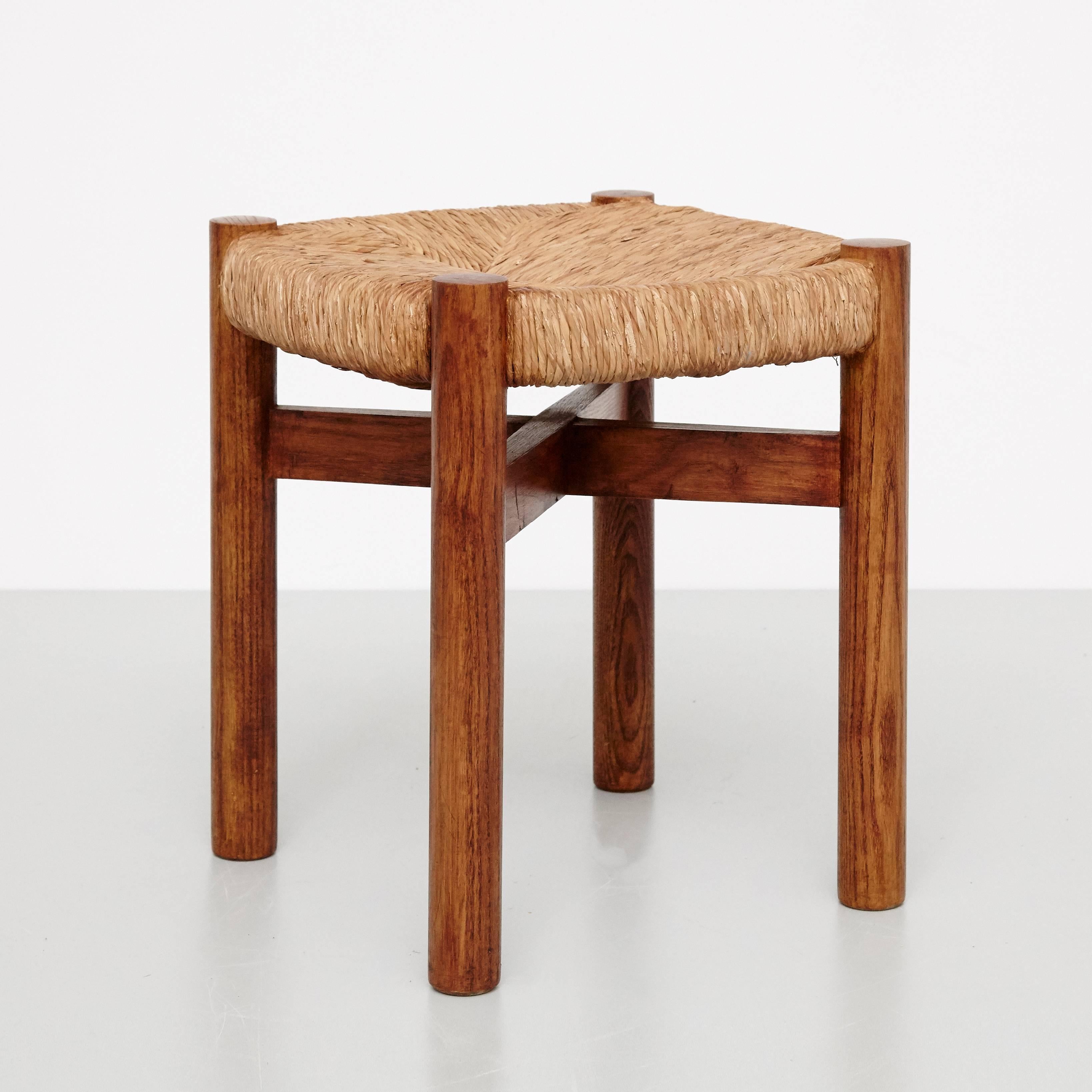 Stool, model meribel, designed by Charlotte Perriand, circa 1950.
Manufactured in France.
Wood and rattan. 

In good original condition, with minor wear consistent with age and use, preserving a beautiful patina.

Charlotte Perriand