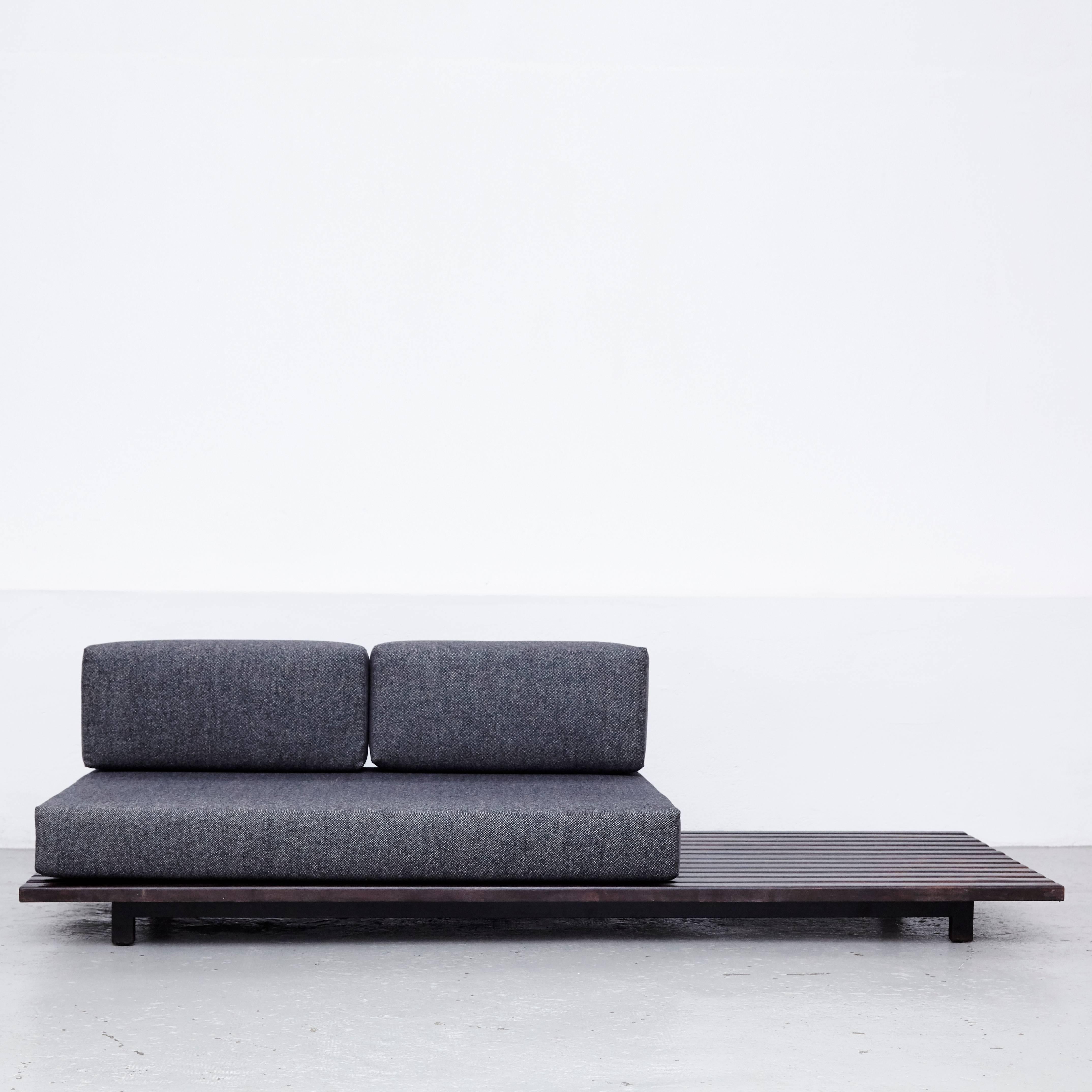 Low bench designed by Charlotte Perriand, circa 1950.
Manufactured by Steph Simon (France) circa 1950.
Wood, lacquered metal frame and legs.

The cushions has been produced now according to the original measurements with high quality wool