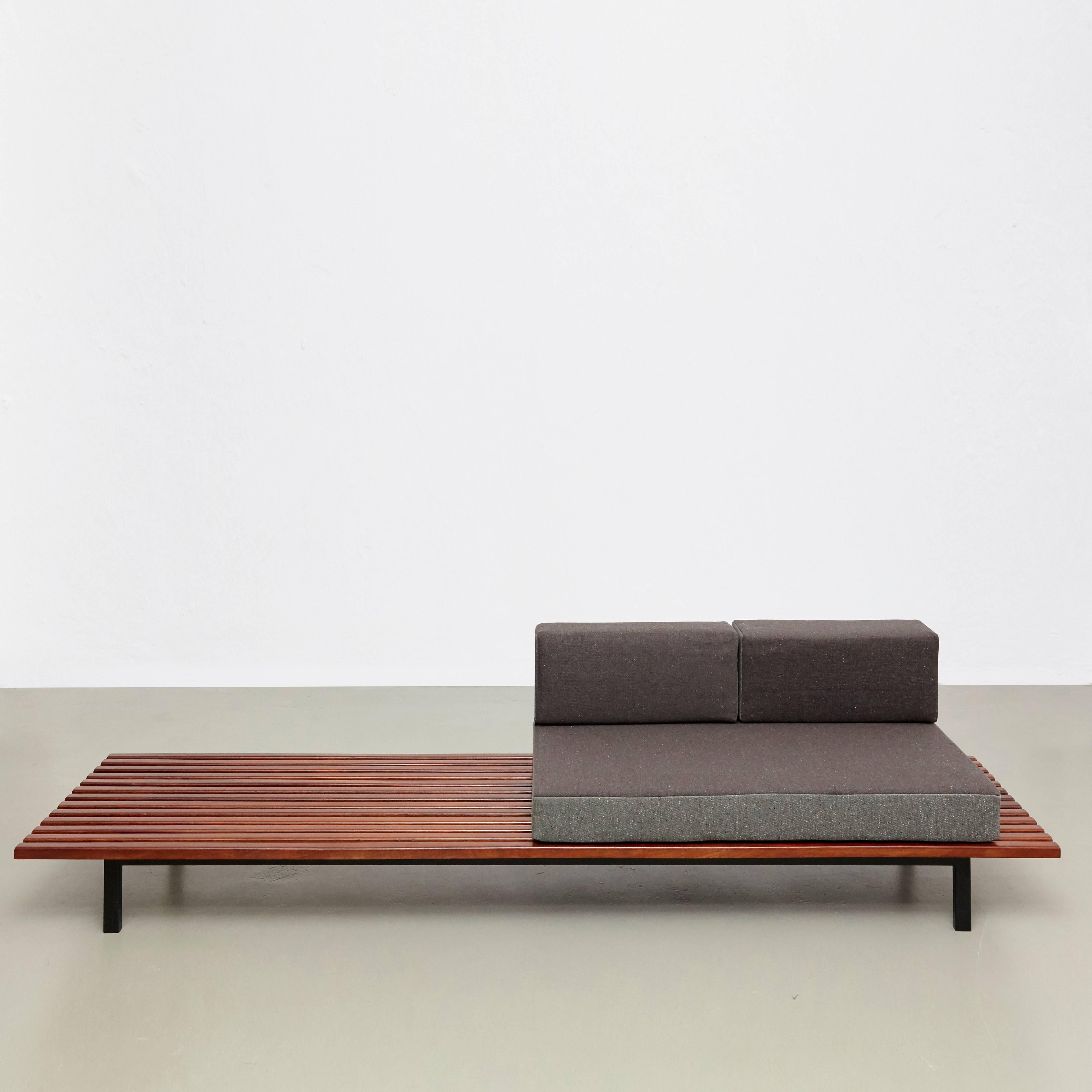 Bench from Cite Cansado, Mauritania, designed by Charlotte Perriand.
Mahogany wood, oak, lacquered metal and fabric.

In good original condition, with minor wear consistent with age and use, preserving a beautiful patina. 

The cushions has