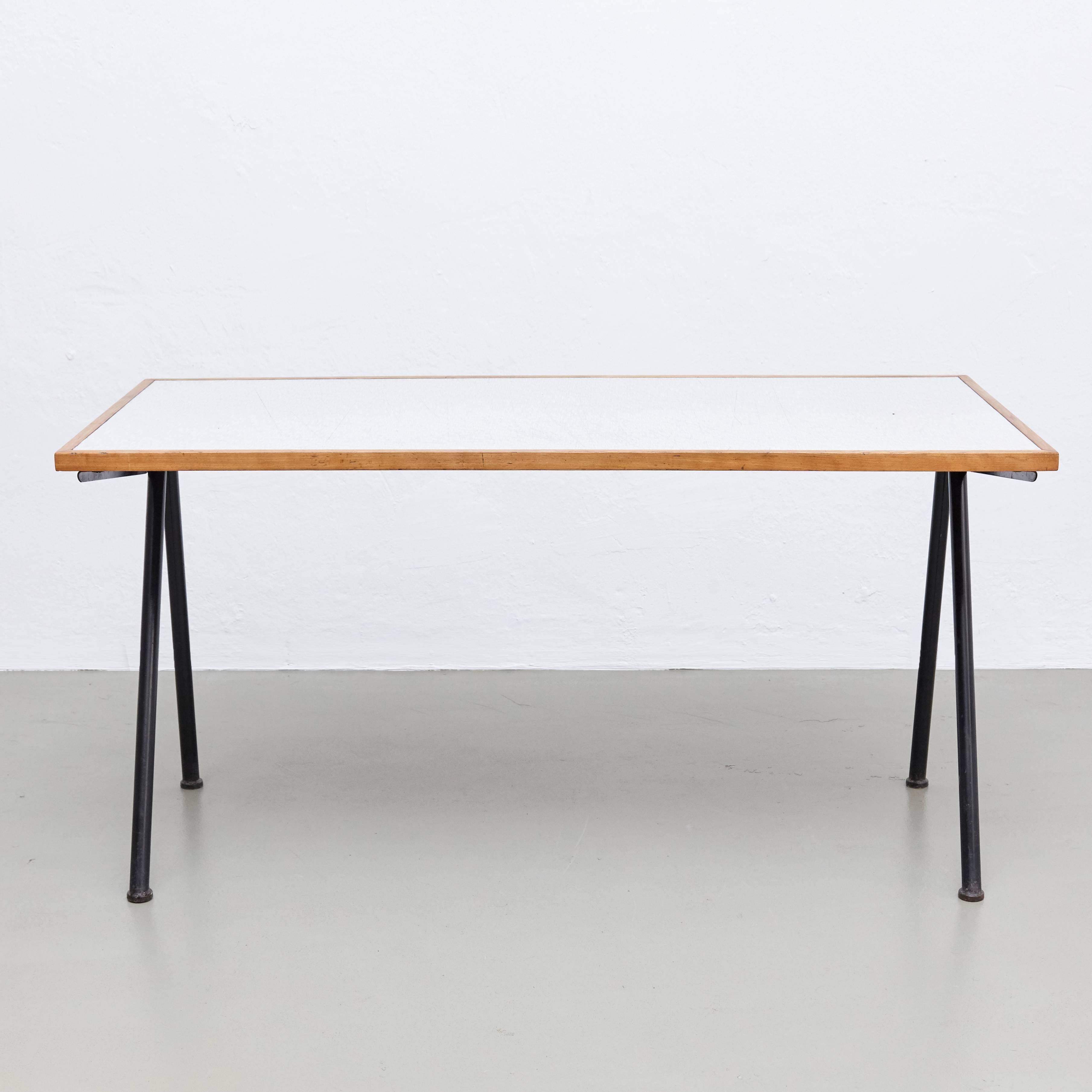 Compass desk designed by Jean Prouvé in 1953, produced in 1955 for the internationale Universite, manufactured by Ateliers Jean Prouvé.

In good original condition, with minor wear consistent with age and use, preserving a beautiful