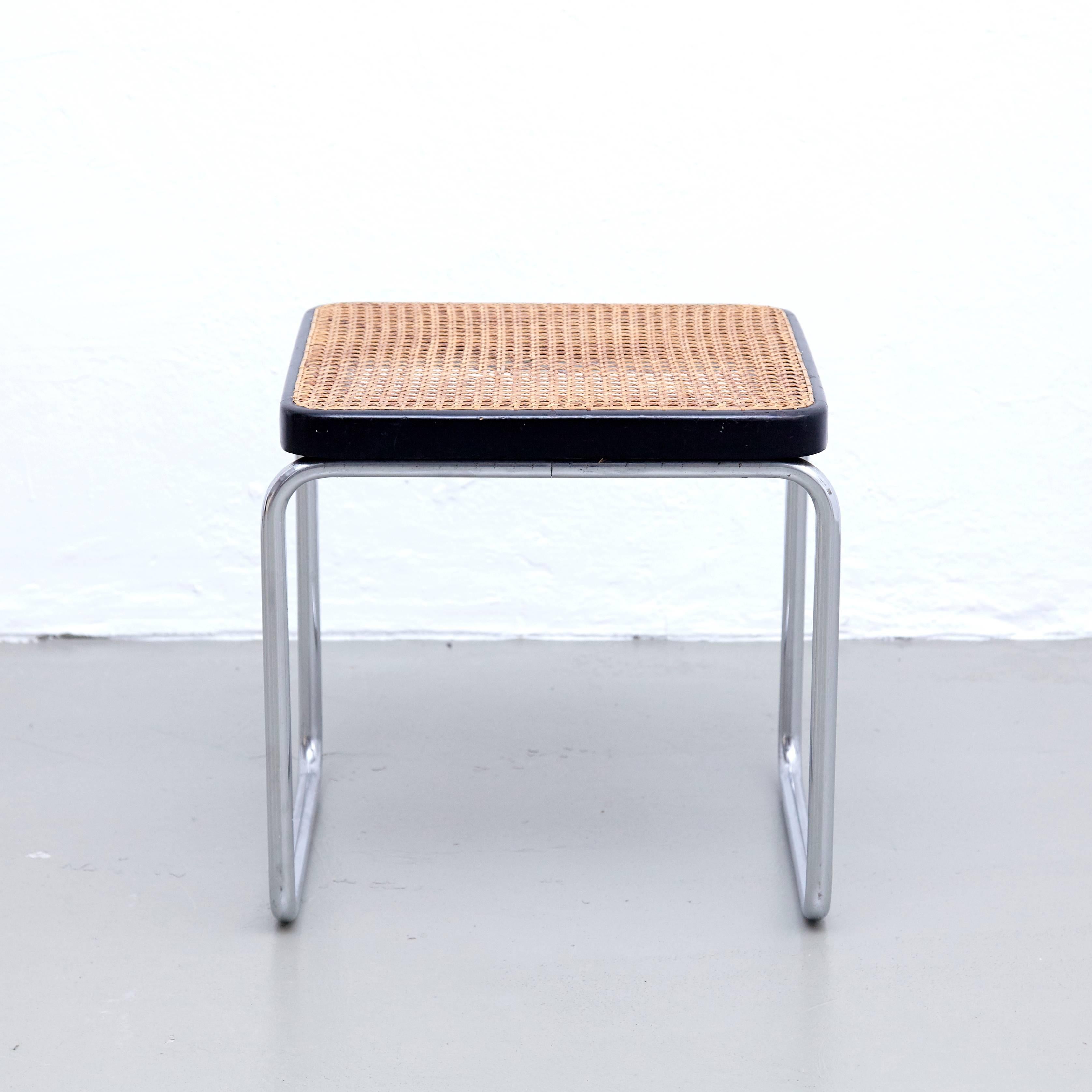 Stool designed by Marcel Breuer 
Manufactured by Thonet.

Metal pipe frame with wood structure and rattan.

In good original condition, with minor wear consistent with age and use, preserving a beautiful patina.

Marcel Breuer (1902 –1981),