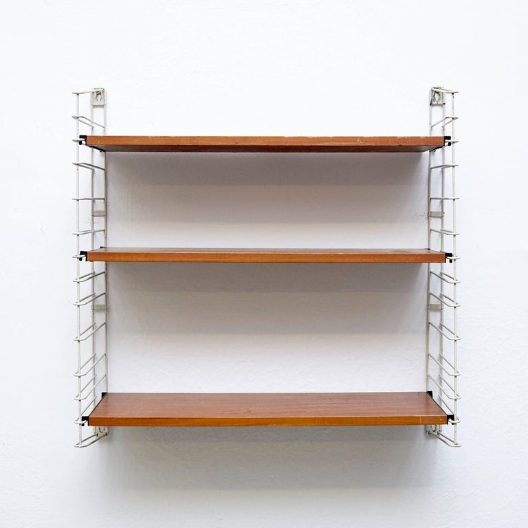Modular shelves designed by Adriaan D. Dekker, circa 1960.
Manufactured by Tomado in the Netherlands.

It possible to fit multiple shelves together, thus achieving a personalized/modular shelving system.

In good original condition with minor