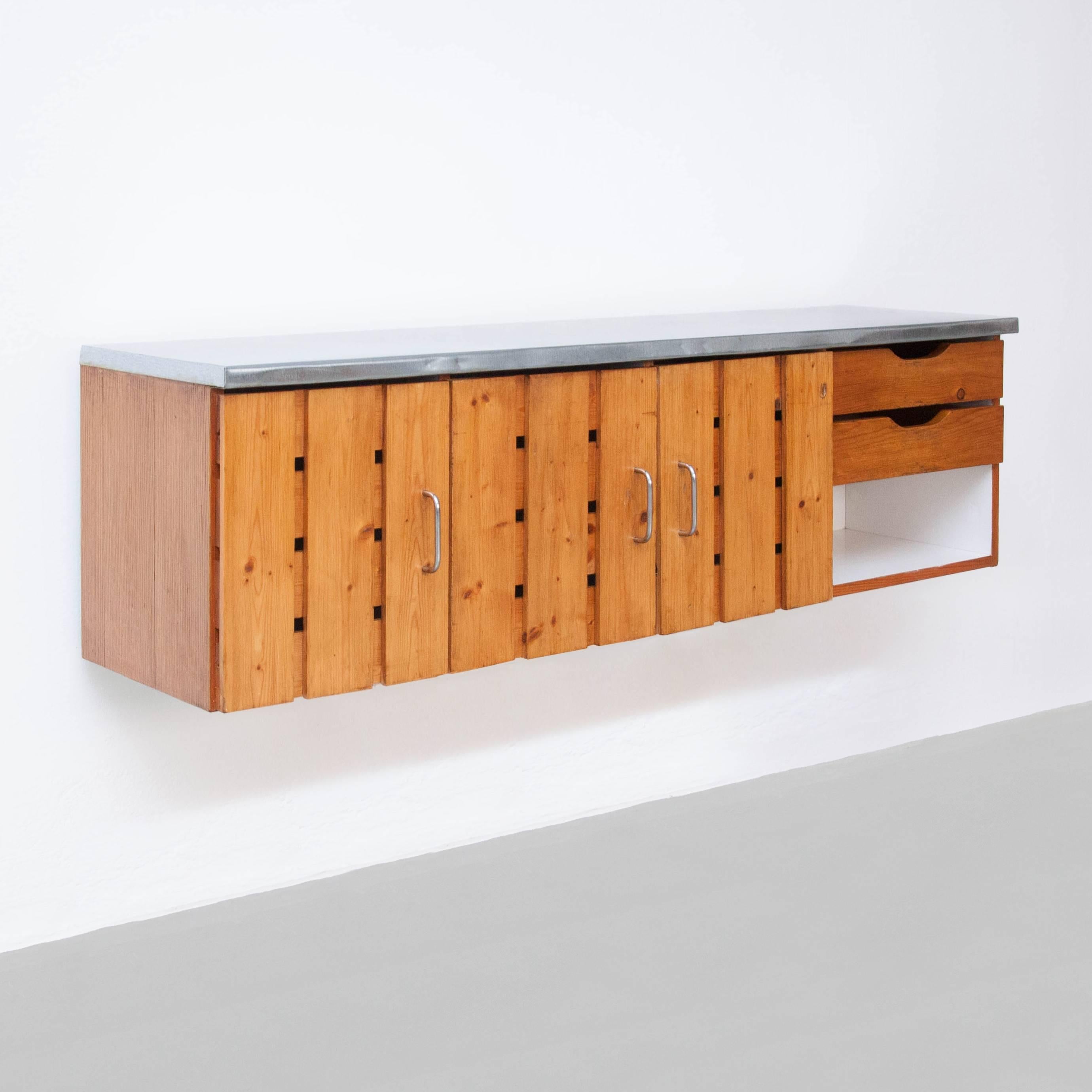 Sideboard designed by Charlotte Perriand for Les Arcs, circa 1960. 
Manufactured in France.
Pinewood and steel.

In good original condition, with minor wear consistent with age and use, preserving a beautiful patina with some scratches and