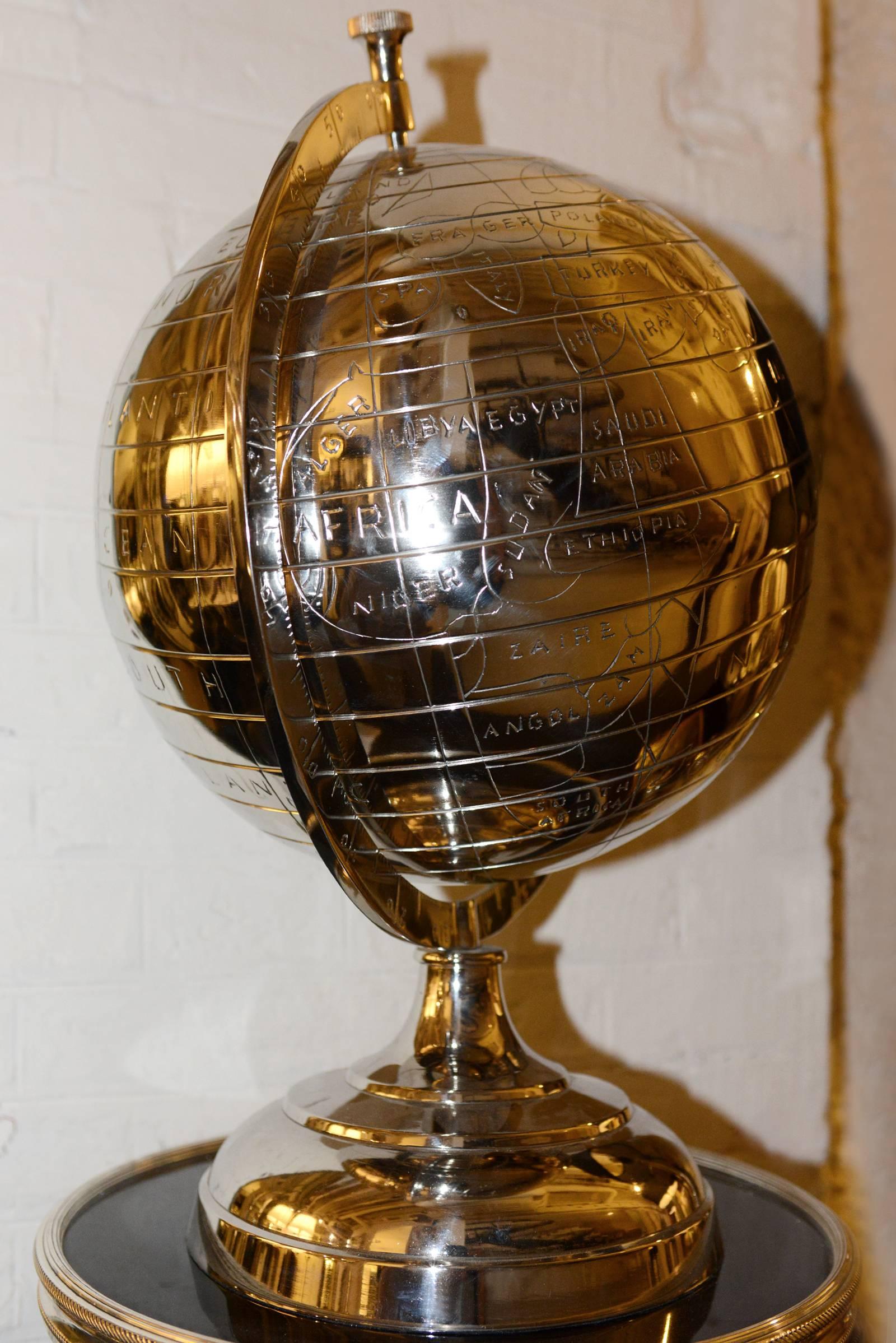 Globe on base in nickel finish.
Available in antique brass finish.
