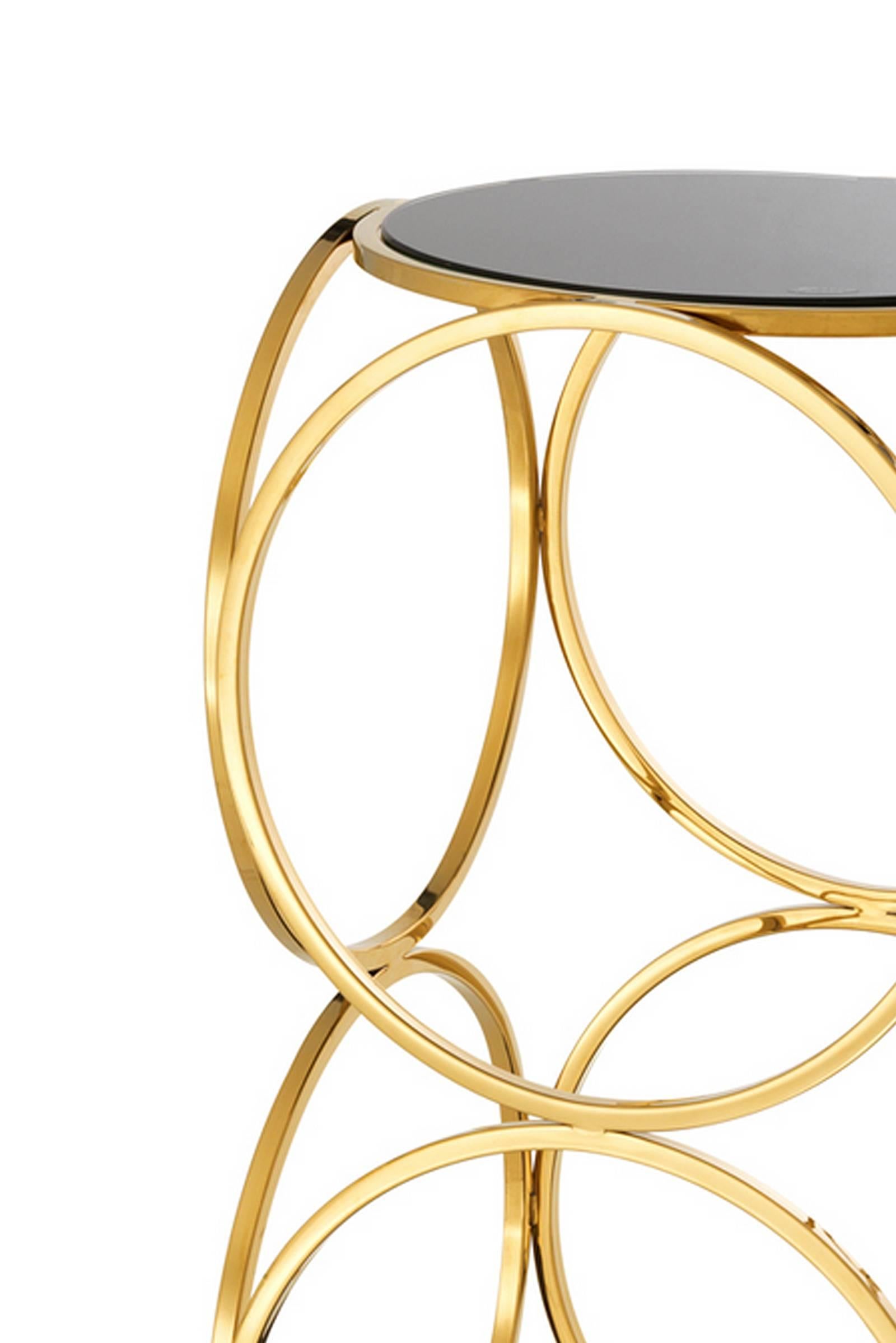 Side table rings in gold finish with black glass top and marble base.
Available in polished stainless steel, price: € 1550.00.
.