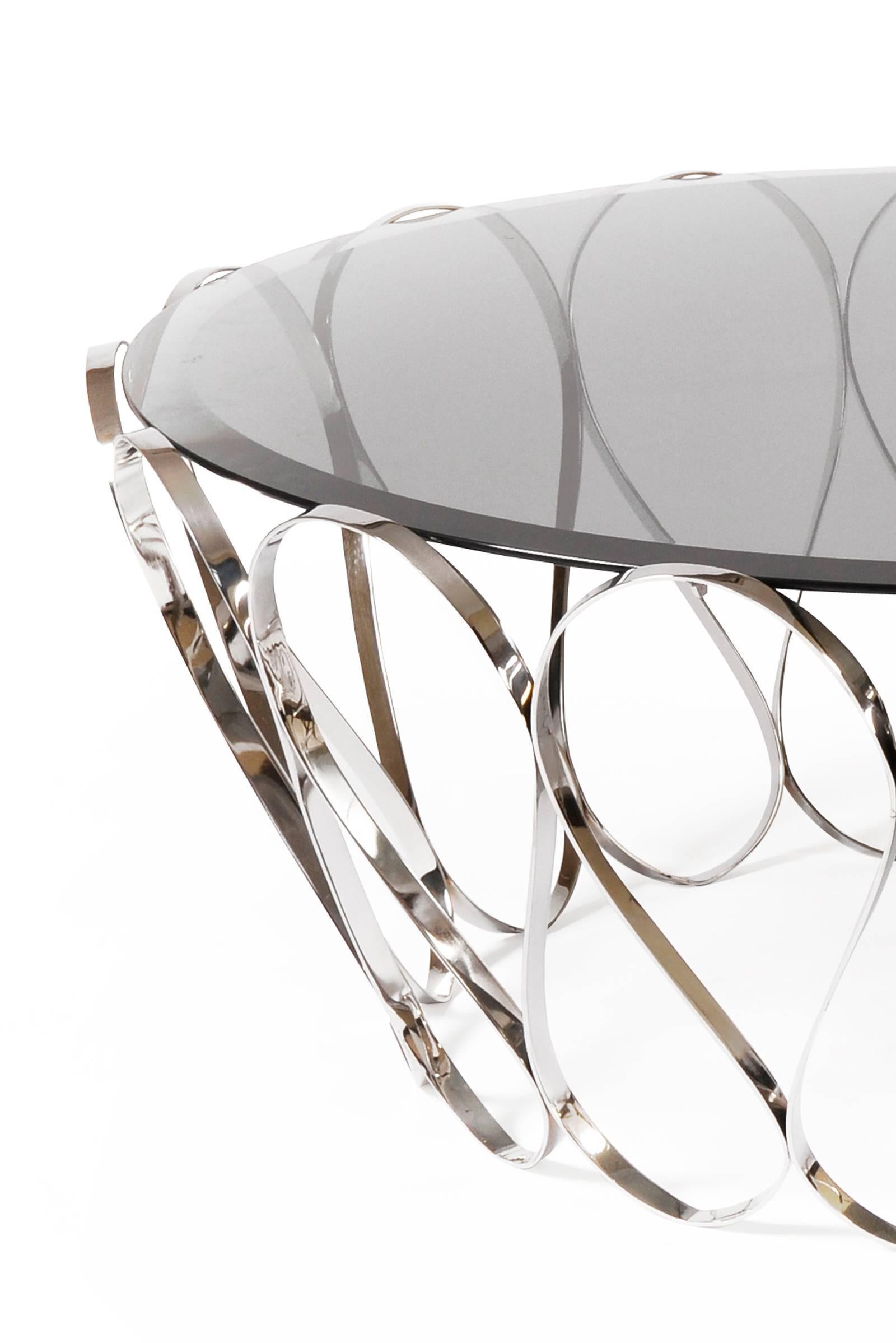 Coffee table waterflor with tempered smoked glass top 
and polished stainless steel structure.

