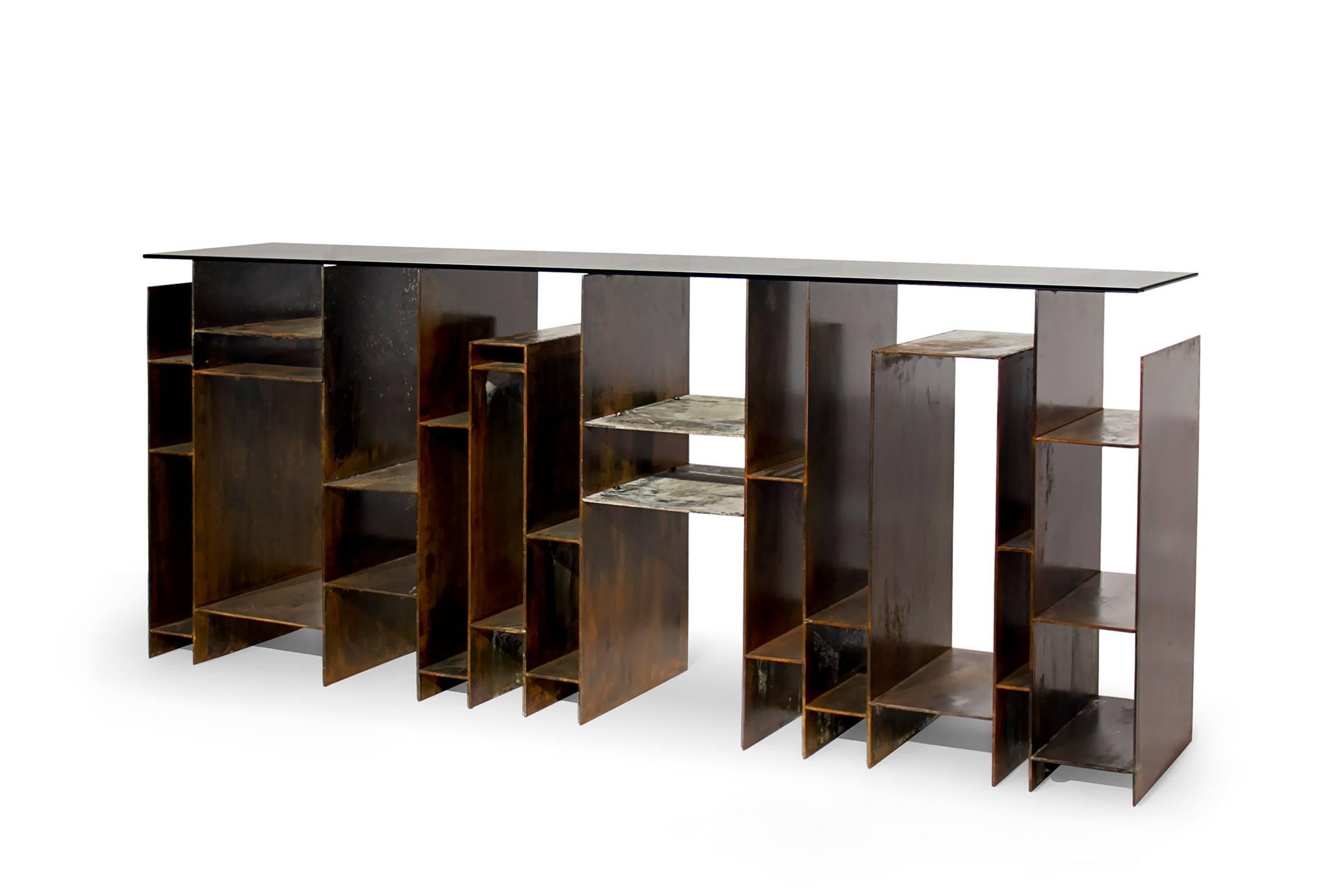 Console table acid iron with bronze glass top
and iron base with acid reaction finish.
