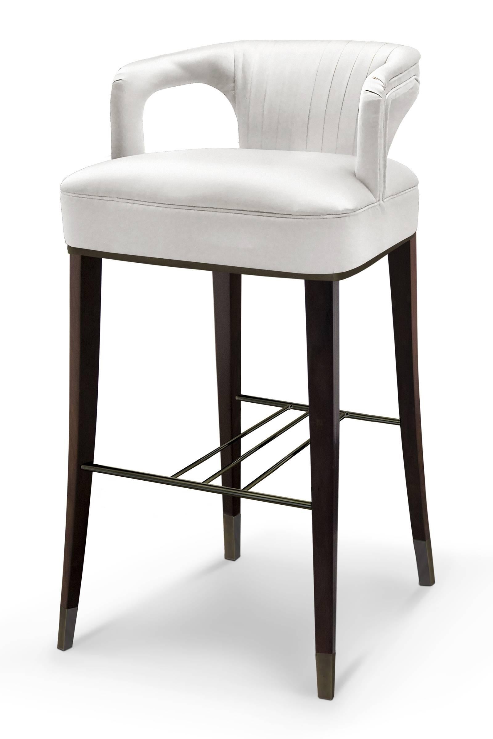 Bar stool Orka made with cotton satin fabric,
oak with walnut stain and aged brass details.
