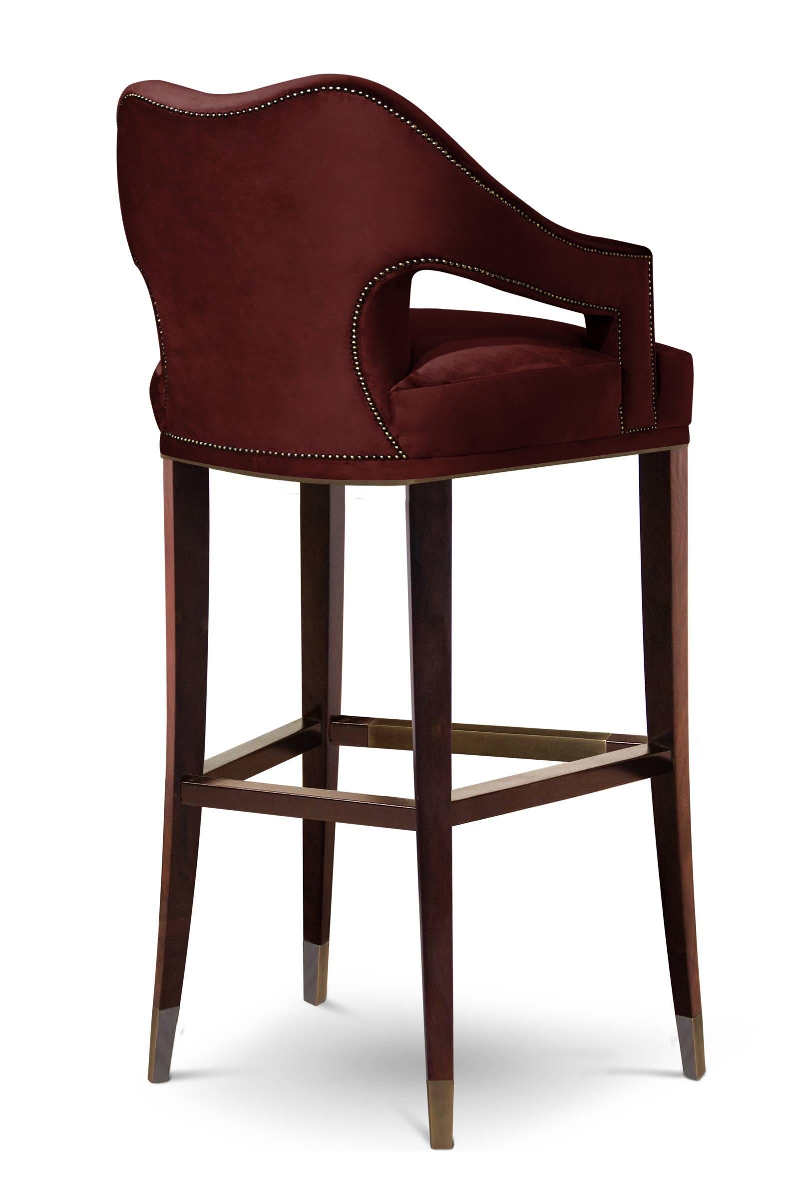 Bar stool Twenty made upholstered and covered with deep
red cotton velvet fabric.
Structure in solid ash wood with walnut stained and with aged 
brass details. Nails in bronze Renaissance finish.
Also available with other fabrics colors, on request.
