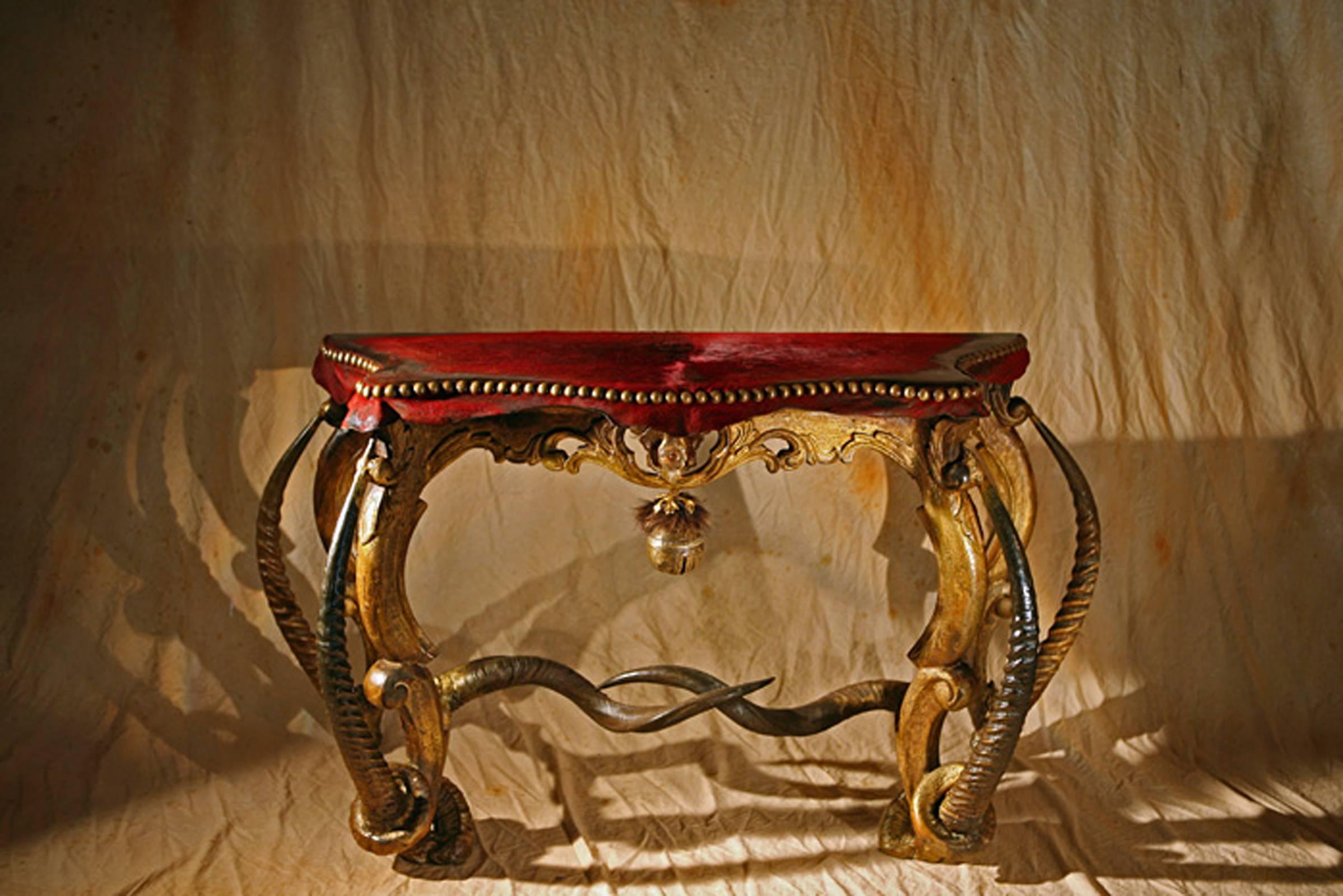 Console table waterbuck made with genuine
Brazilian cow leather, waterbuck horns and Brazilian
cow horns. Hand-carved wood structure. Bronze bell
and bronze nails. Exceptional piece.

 