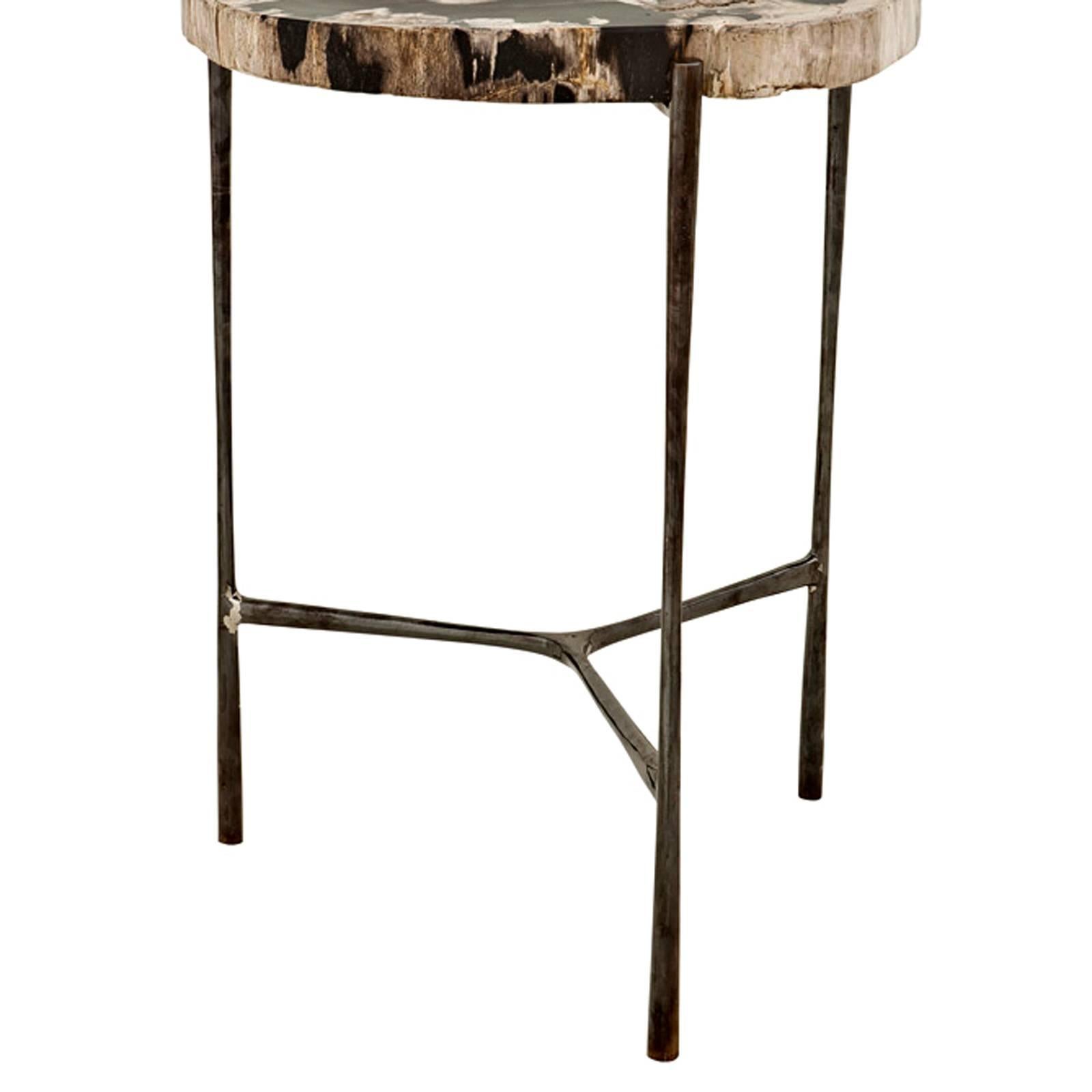 Side table times with petrified 
wood top. Black nickel base. 

