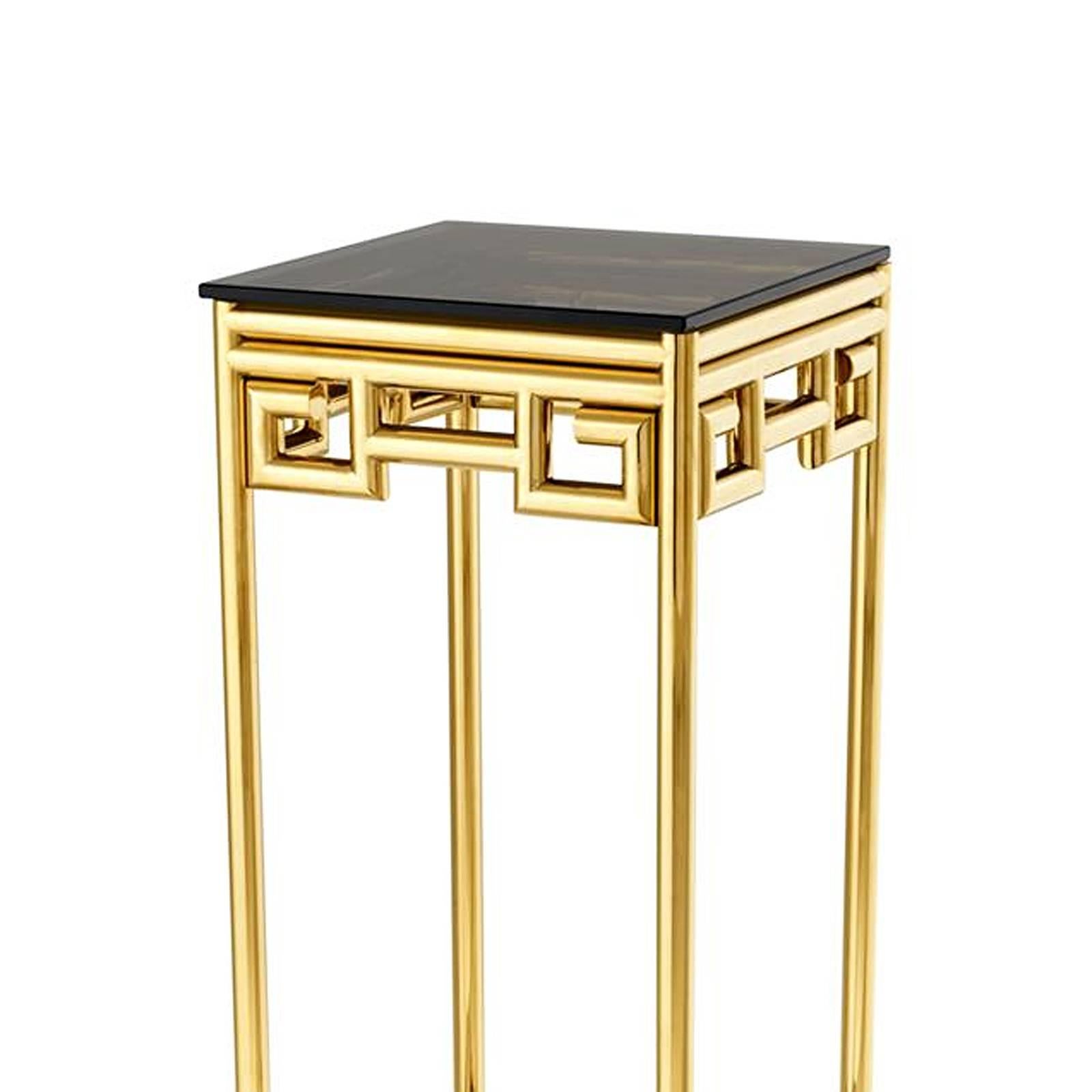 Column Baroque in polished stainless steel
in gold finish with smoked glass top and base.
