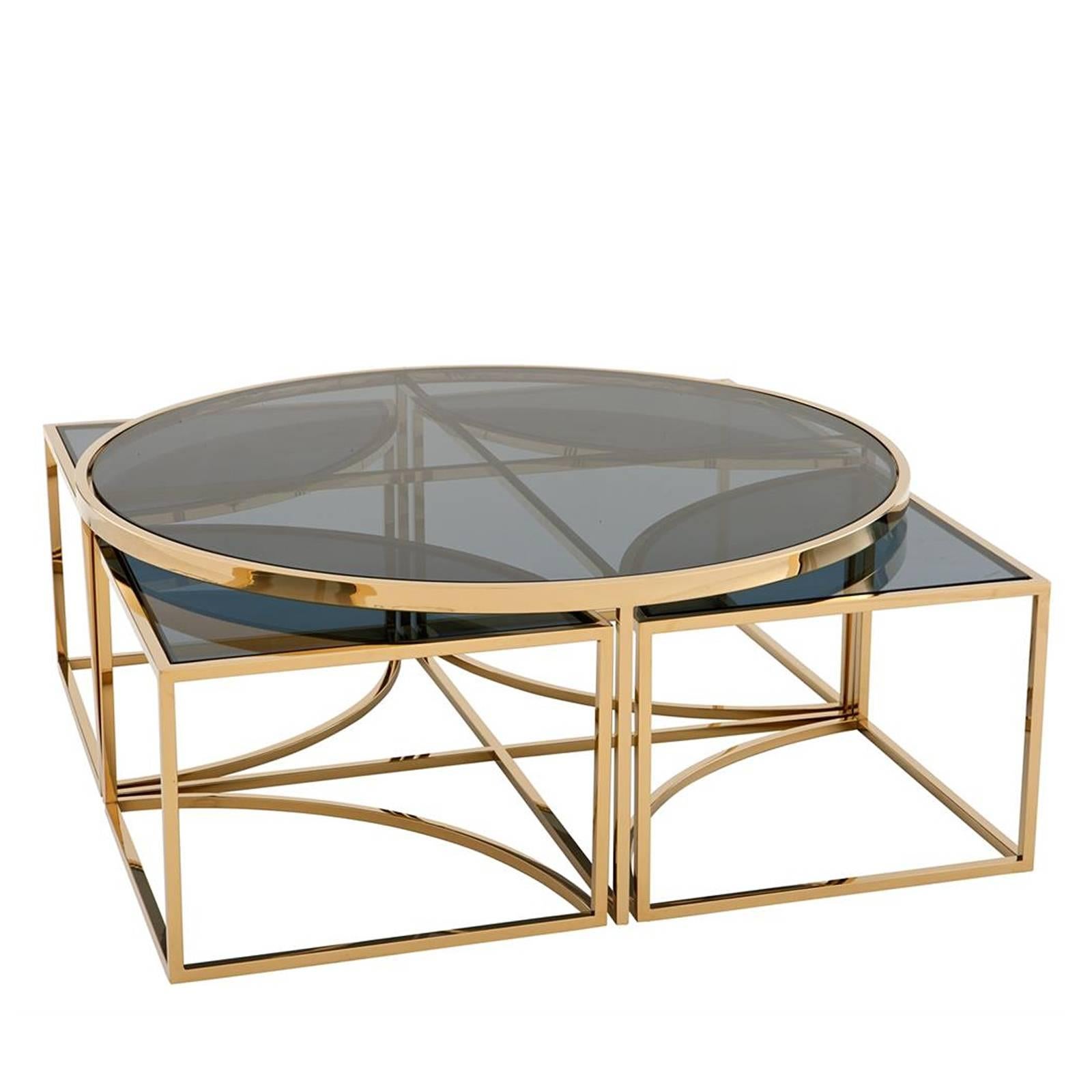 Coffee table four pieces with gold finish structure
and smoked glass top. One side table included four small
side tables. Also available in polished stainless steel
and smoked glass top.
