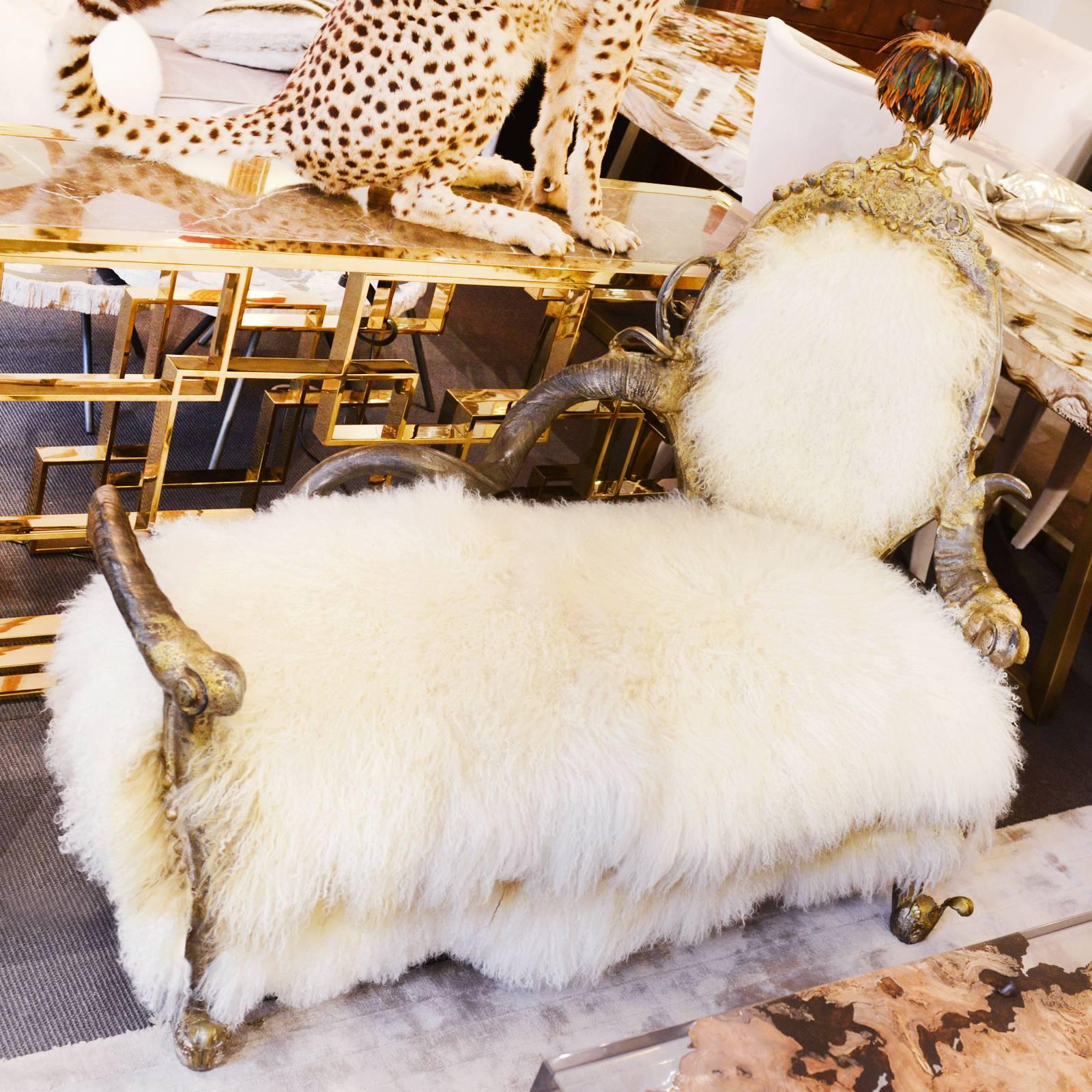Daybed covered with pure lamb wool from
Mongolia. With one real zebu horn and one real kudu horn.
With tassel in real ostrich feathers. Nails and finishes in
bronze. Exceptional piece made in France in 2017.
