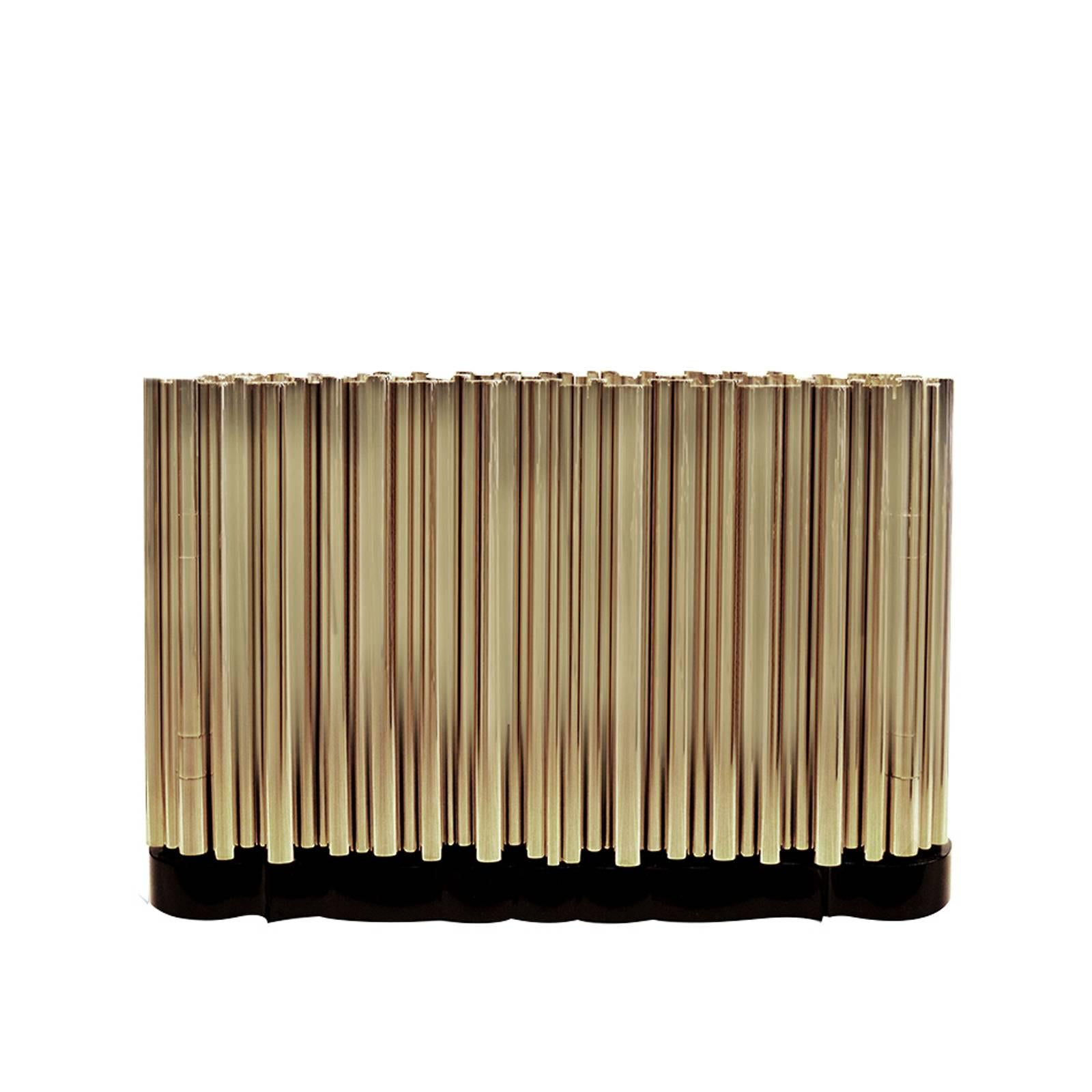 Nightstand brass tubes with polished brass tubes gold-plated
that wrap an exotic wooden structure, creating a clever juxtaposition.

 