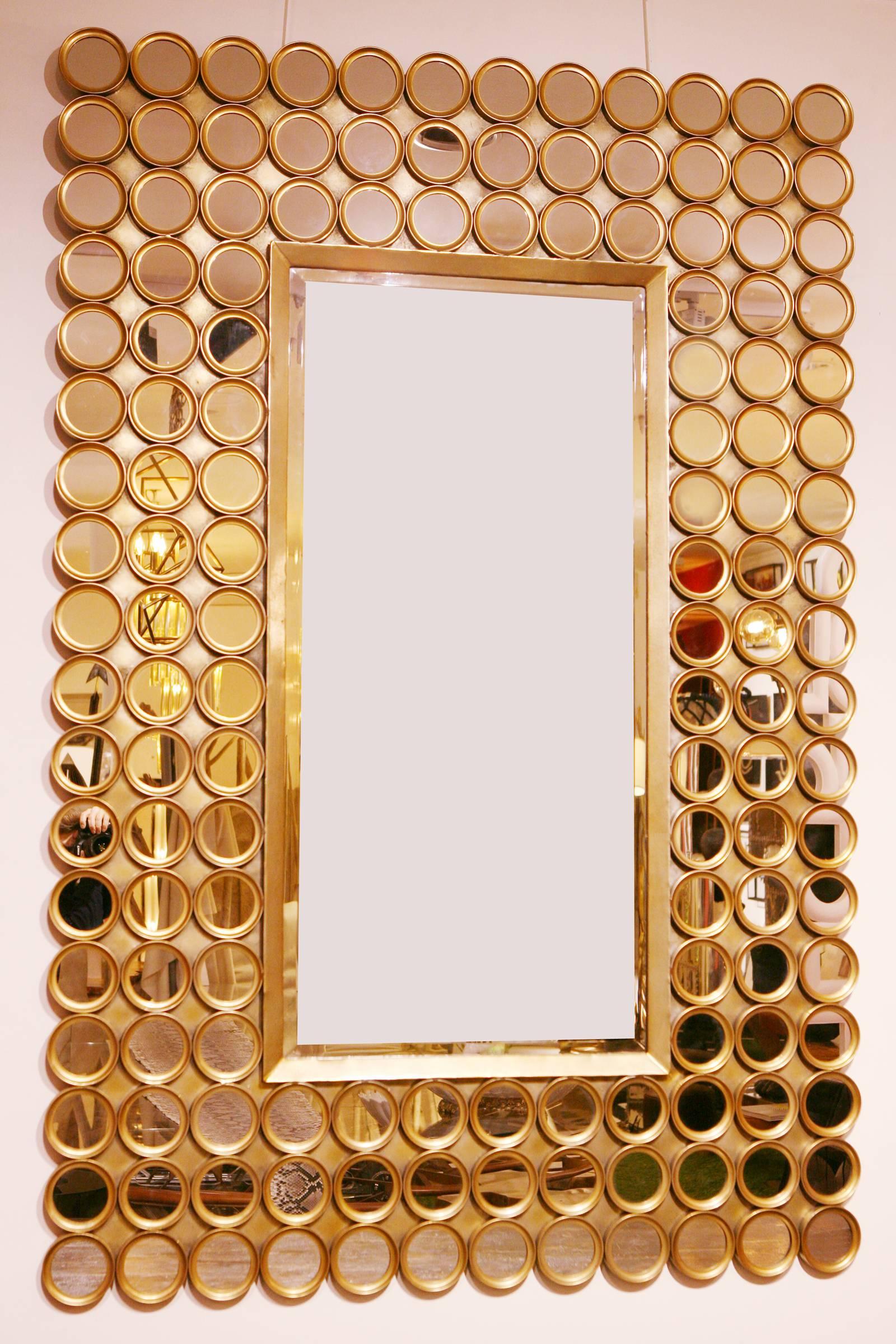 144 Facets mirror, with structure in mate gilded metal.
With rectangular center mirror in bevelled mirror glass.
