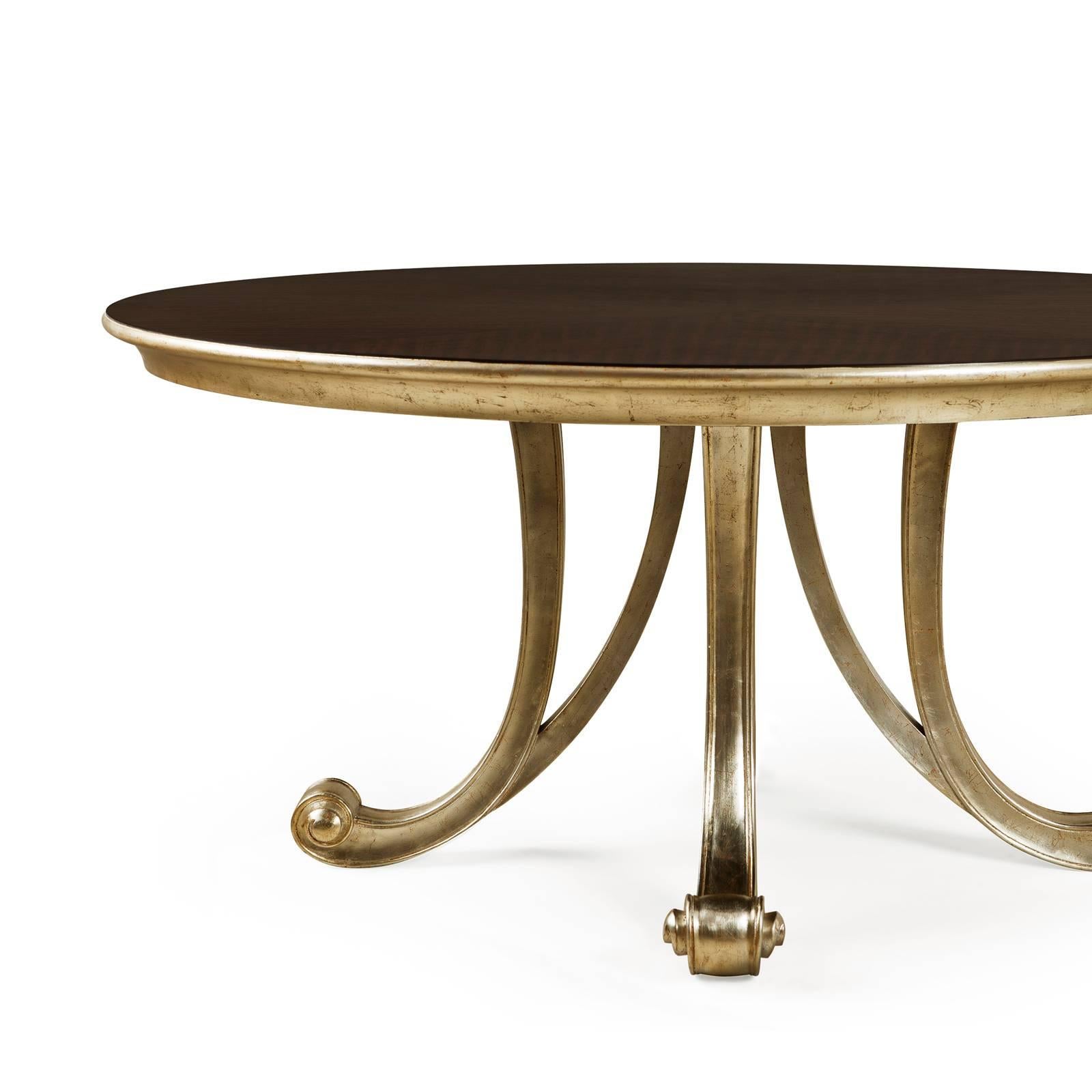 Round table Orcade with hand-crafted solid mahogany wood 
structure. Base and top's frame hand-painted with high quality
gold paint. With a hand-varnished top.
 