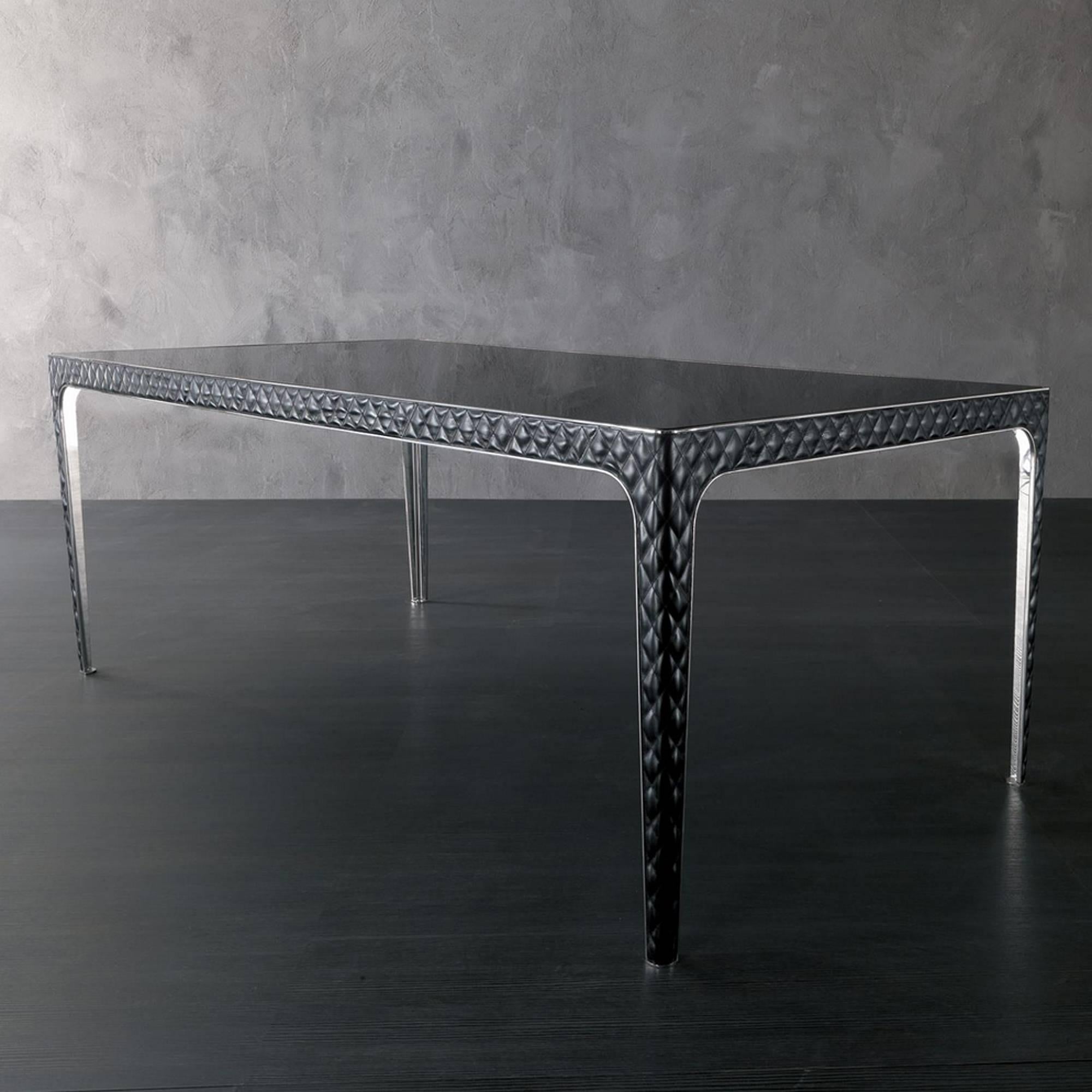 Dining table with structure in polished stainless steel
with black glass top. Legs covered with capitonated black 
genuine leather (Cat C).
Available in:
L201,2xD112,2xH76,3cm, price: 15900,00€.
L242,2xD112,2xH76,3cm, price: