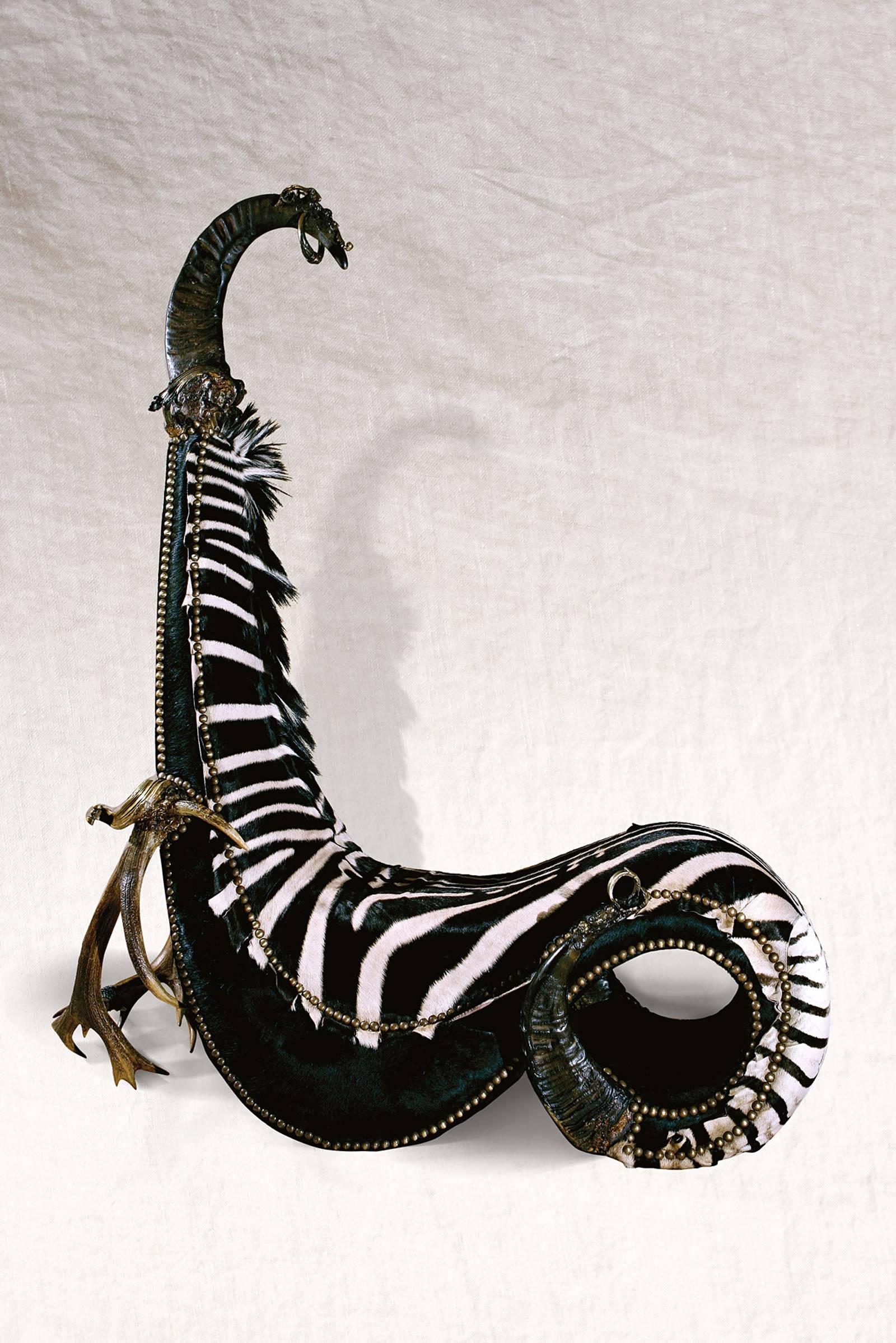 Chair zebra king with zebra skin, armrest with
deer antlers and details and nails in solid bronze. 
