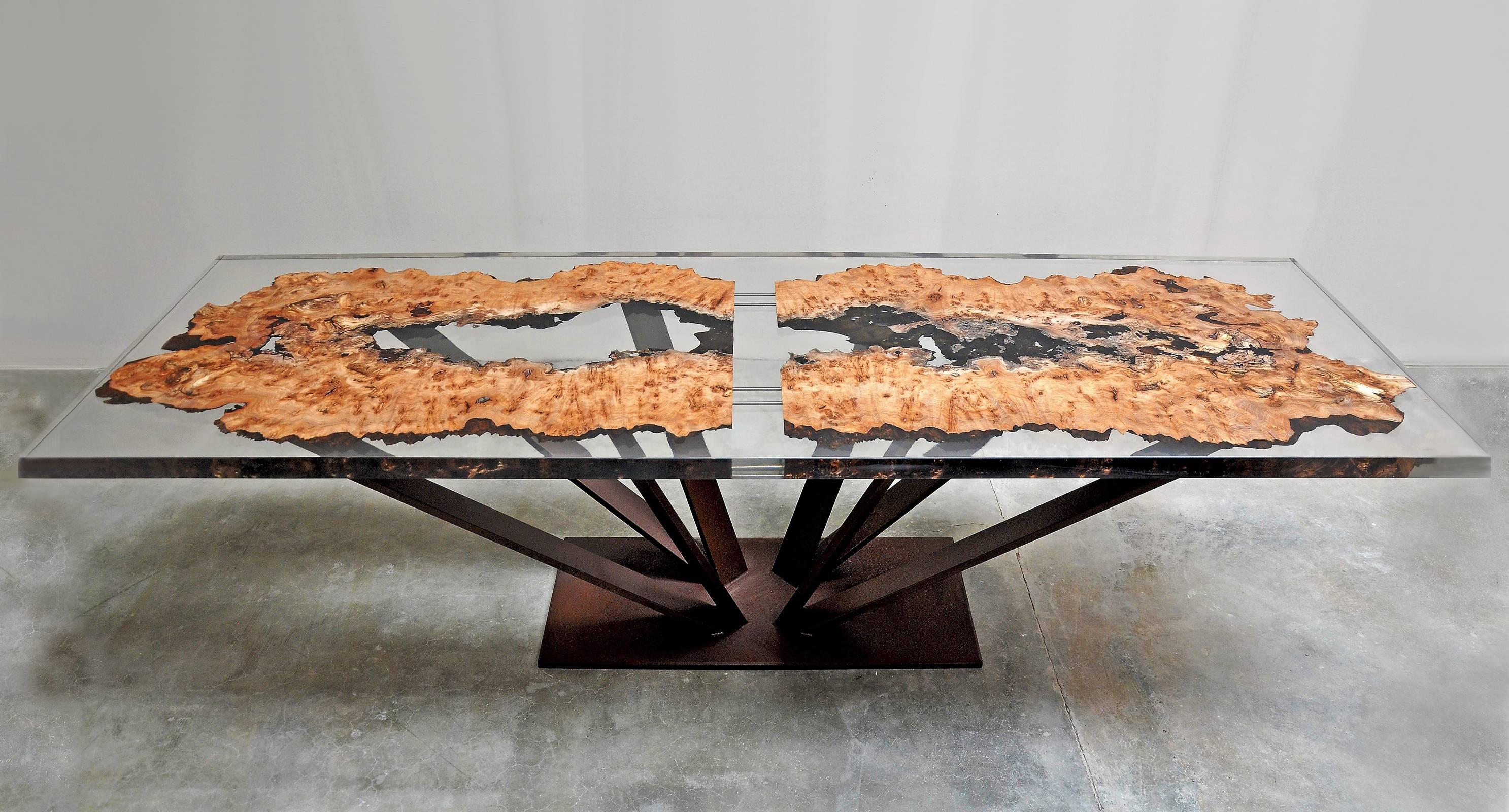 Dining table or conference table in solid elmwood made with the cut of
an elm coated with a strong transparent resin. Top thickness: 5 cm. Base
composed of eight forged metal feet. Made in France in 2017. Exceptional
and unique piece.
