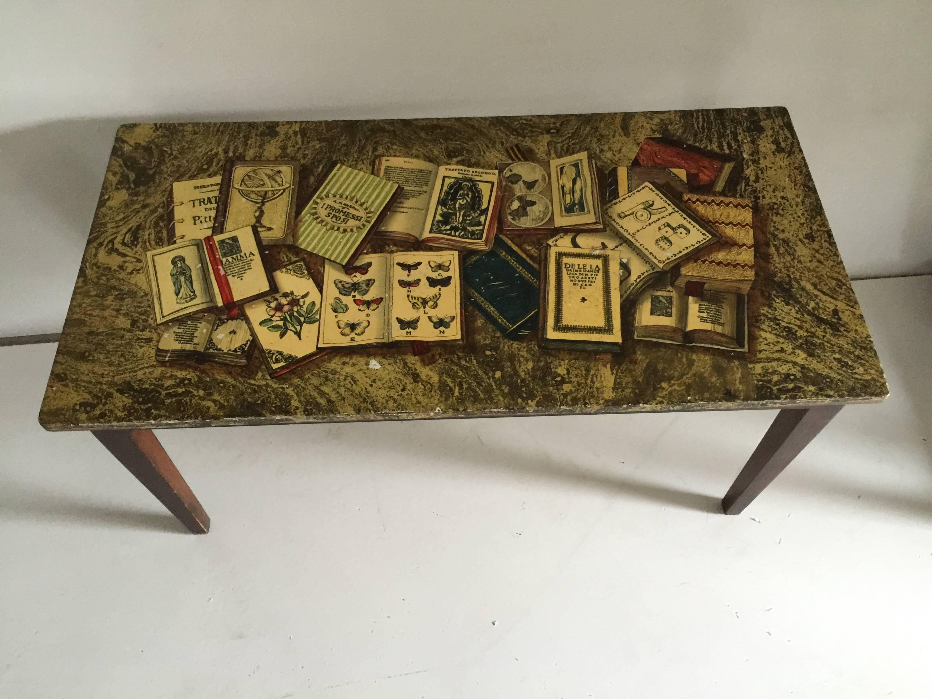 A Piero Fornasetti Libri coffee or cocktail table made in Italy, circa 1950s, decorated with books.