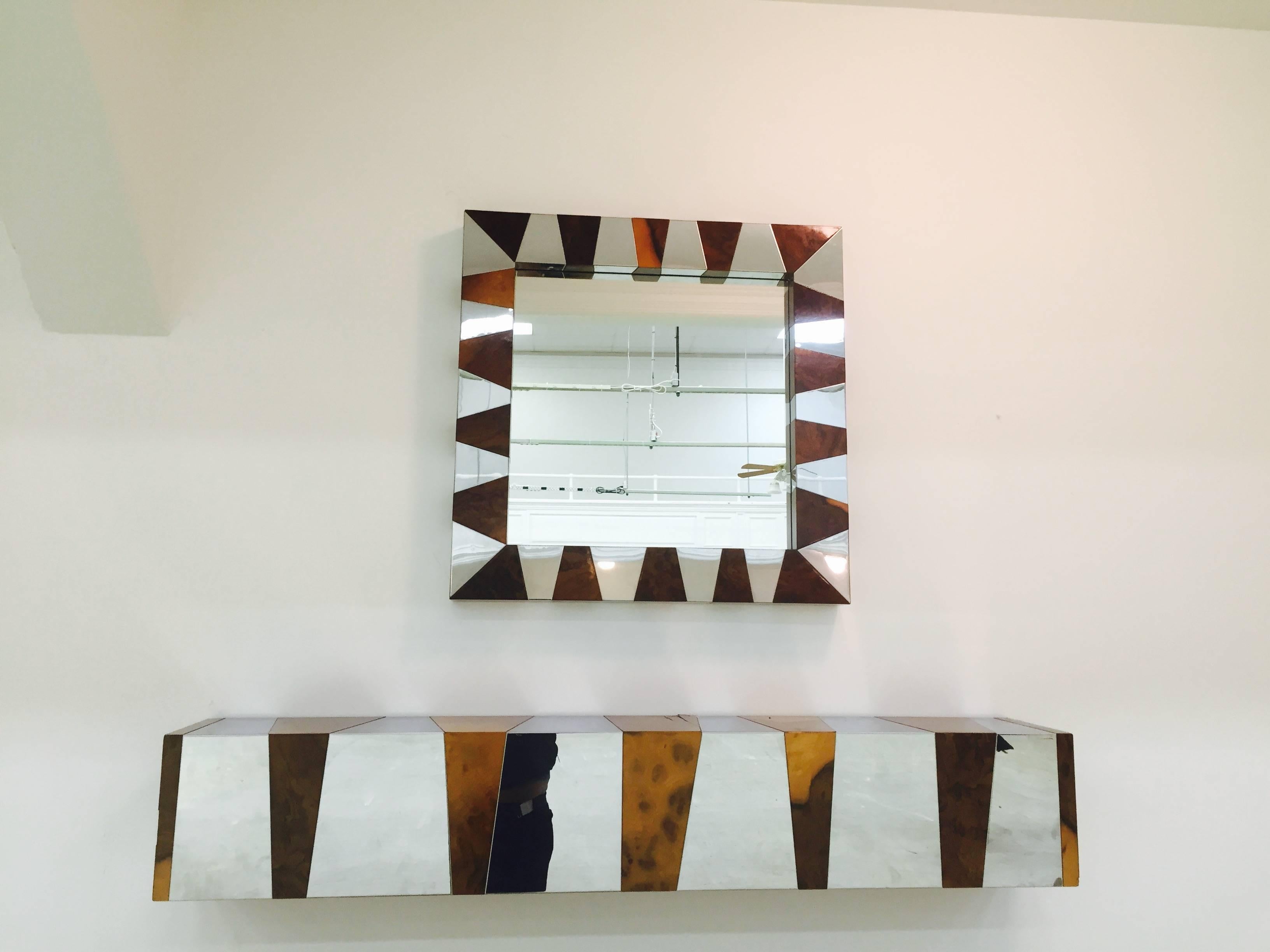 A Paul Evans cityscape floating shelf, or wall-mounted console with mirror in chrome with burl wood, circa 1970s.

Mirror is 30" W x 39.75" H x 3" D
Console is 60" L x 10" H x 10" D.