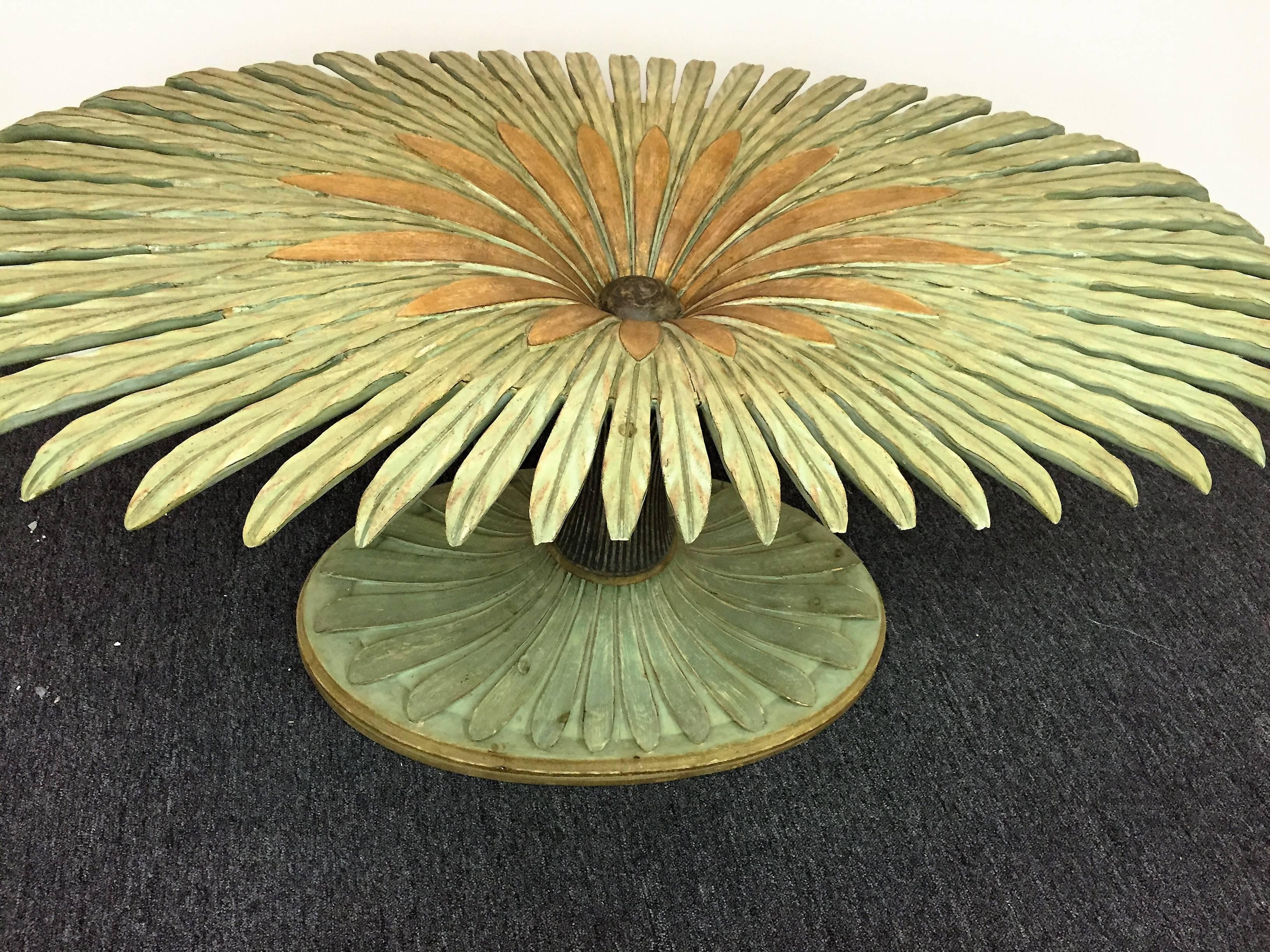 Highly decorative and intricately carved floral form table comprised of wood with a light green and gold applied finish. In the form of a majestic full bloomed flower, this table is inspired by the work of French artist and designer Serge Roche. It