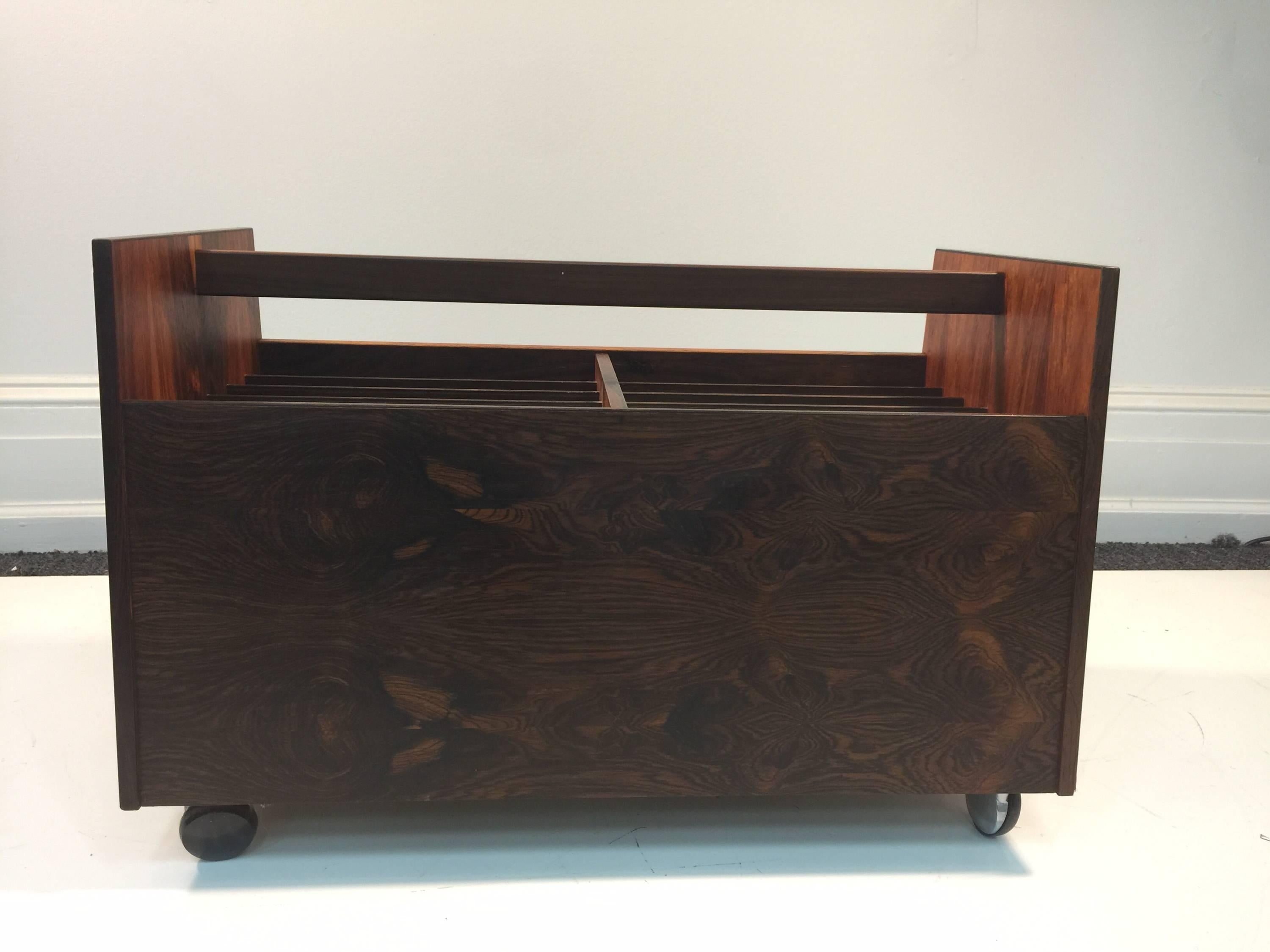 A magnificent Norwegian magazine rack in rosewood designed by Rolf Hesland and produced by Bruksbo.