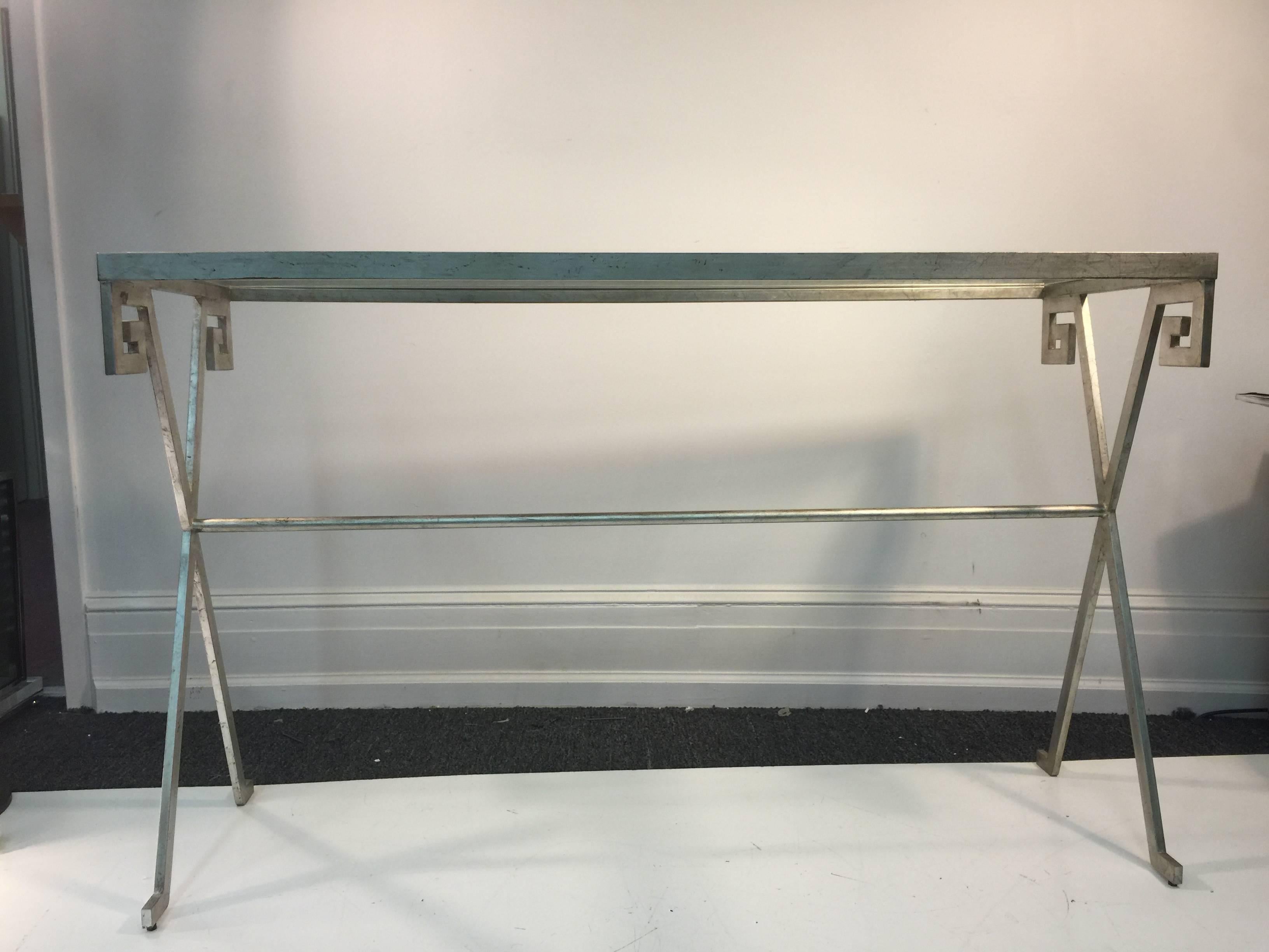 A great pair of console tables in steel with glass top and Greek Key design in the manner of Paul Frankl.
