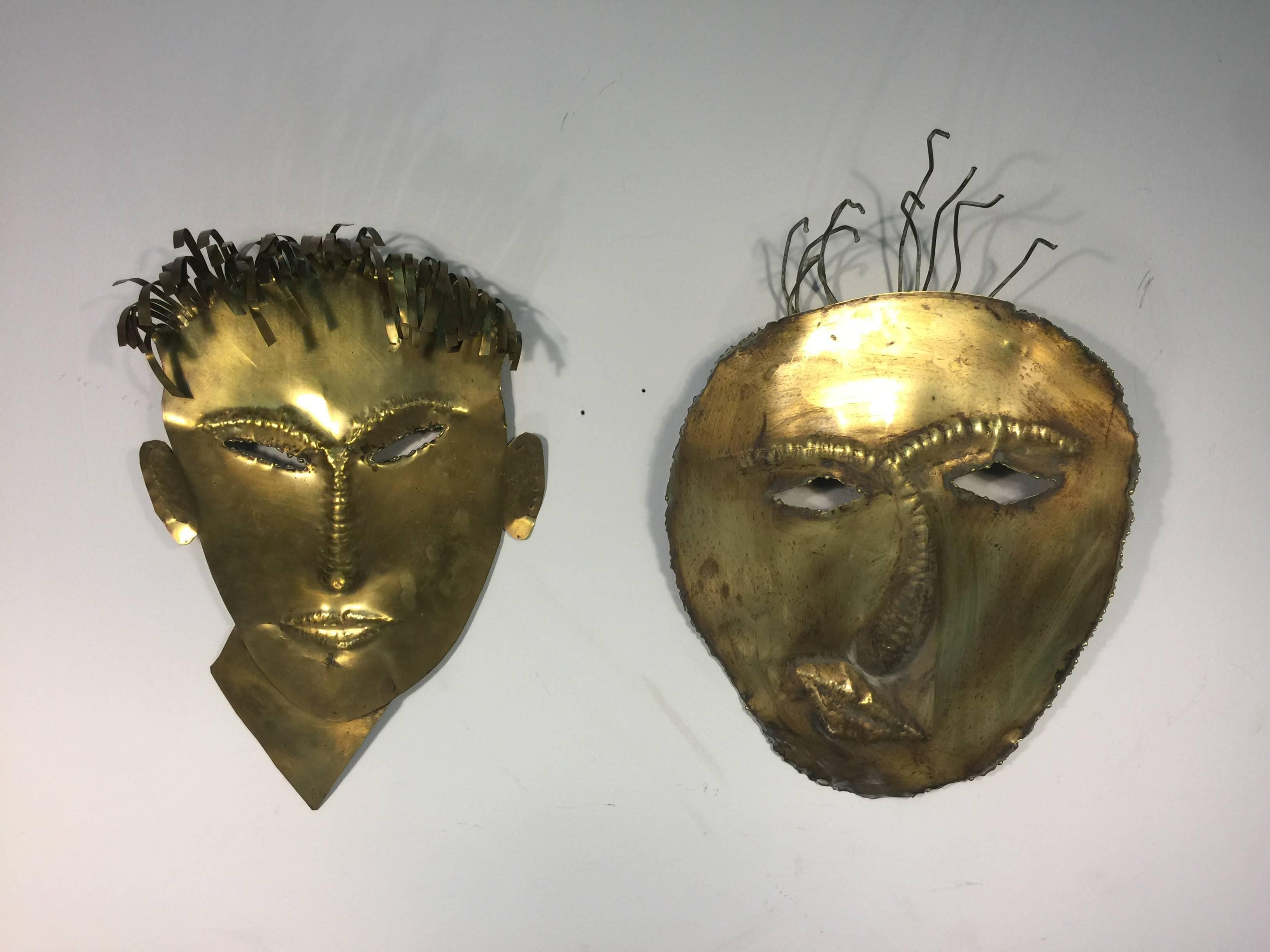 Terrific brass highly stylized male masks or face wall-mounted sculptures in the manner of Hagenauer, circa 1970. Each mask is being sold separately.

Dimensions:
15 H x 22 W x 2.5 D.
13 H x 20 W x 2 D.