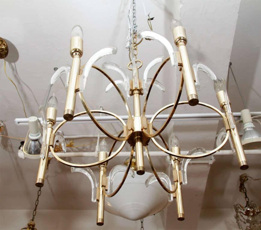 A spectacular brass chandelier with glass leaf or petal accents by Gaetano Sciolari.