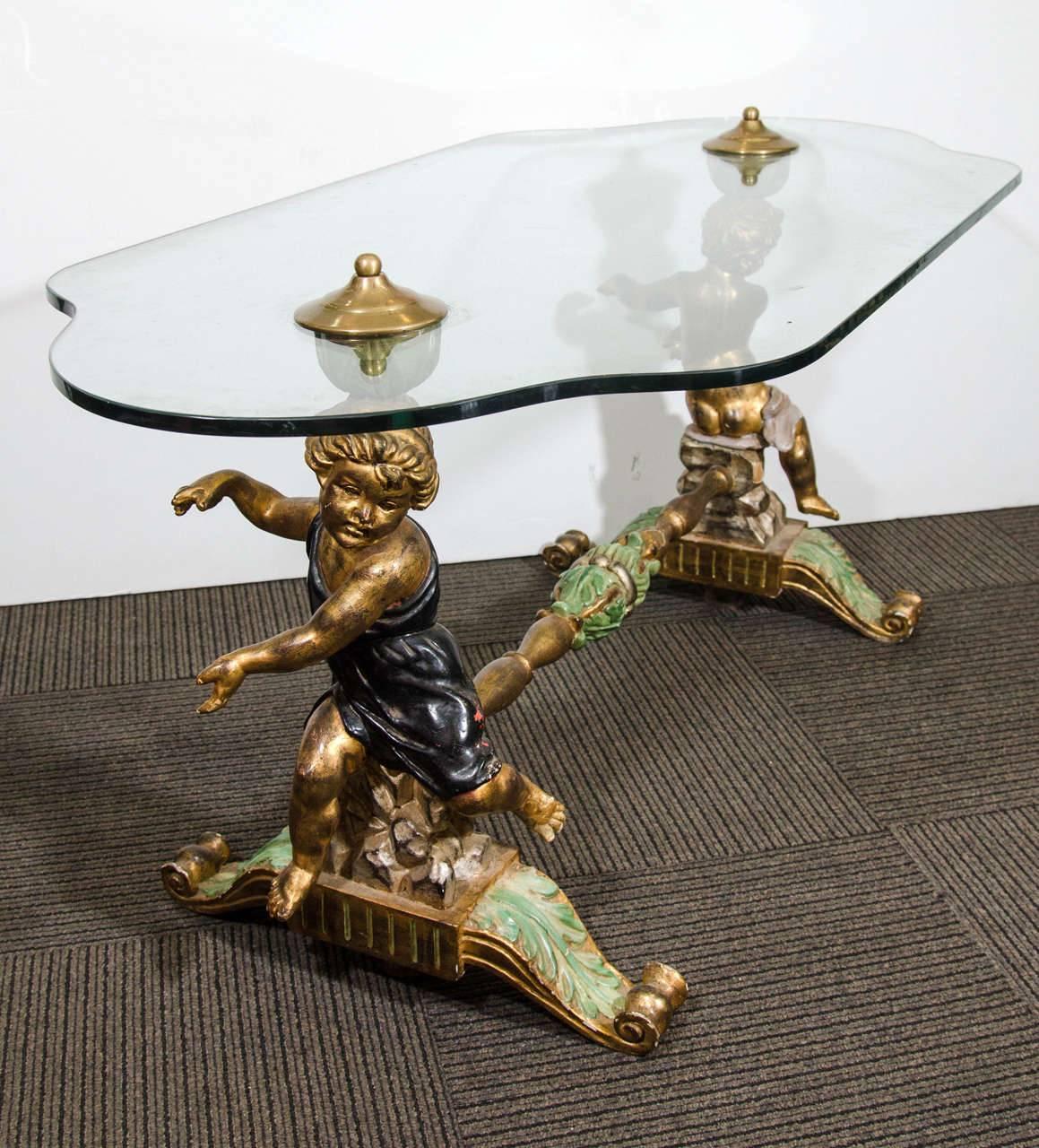 An incredible Italian carved wood and hand-painted coffee or cocktail table with putti or cherubs.