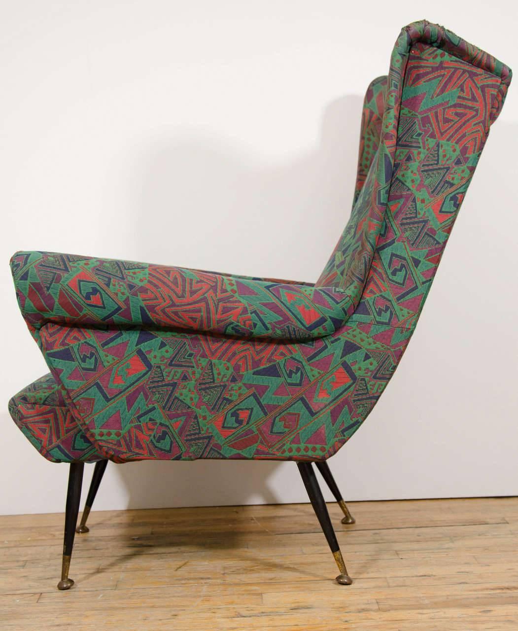 A wonderful pair of Italian wingback armchairs or lounge chairs upholstered in original aqua fabric with colorful, abstract design, circa 1950.